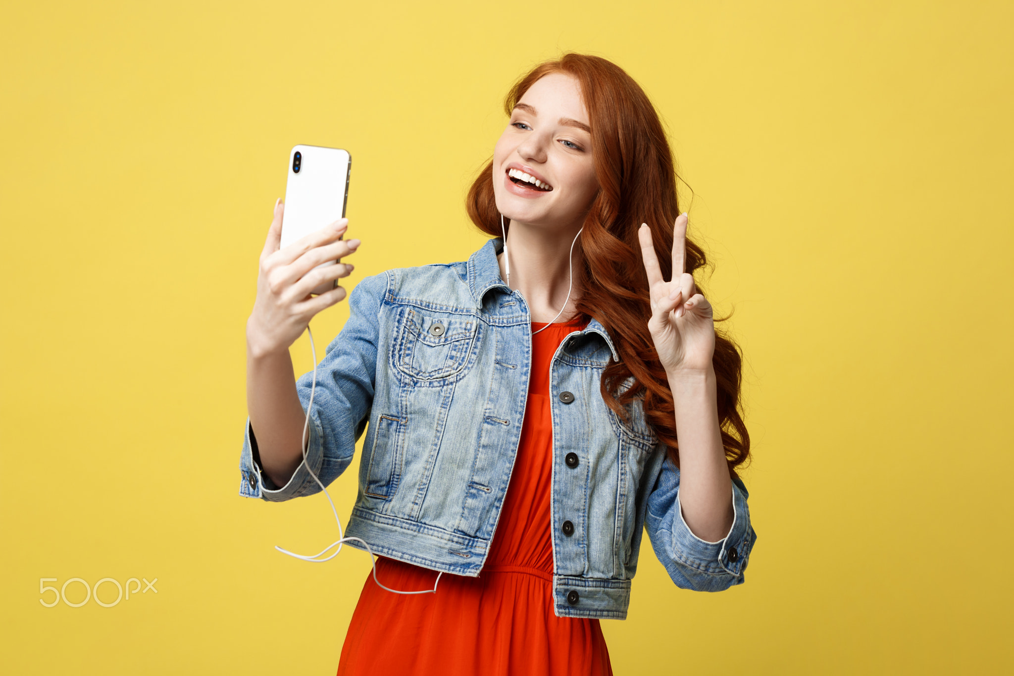 Lifestyle Concept: Young cheerful woman posing while photographing