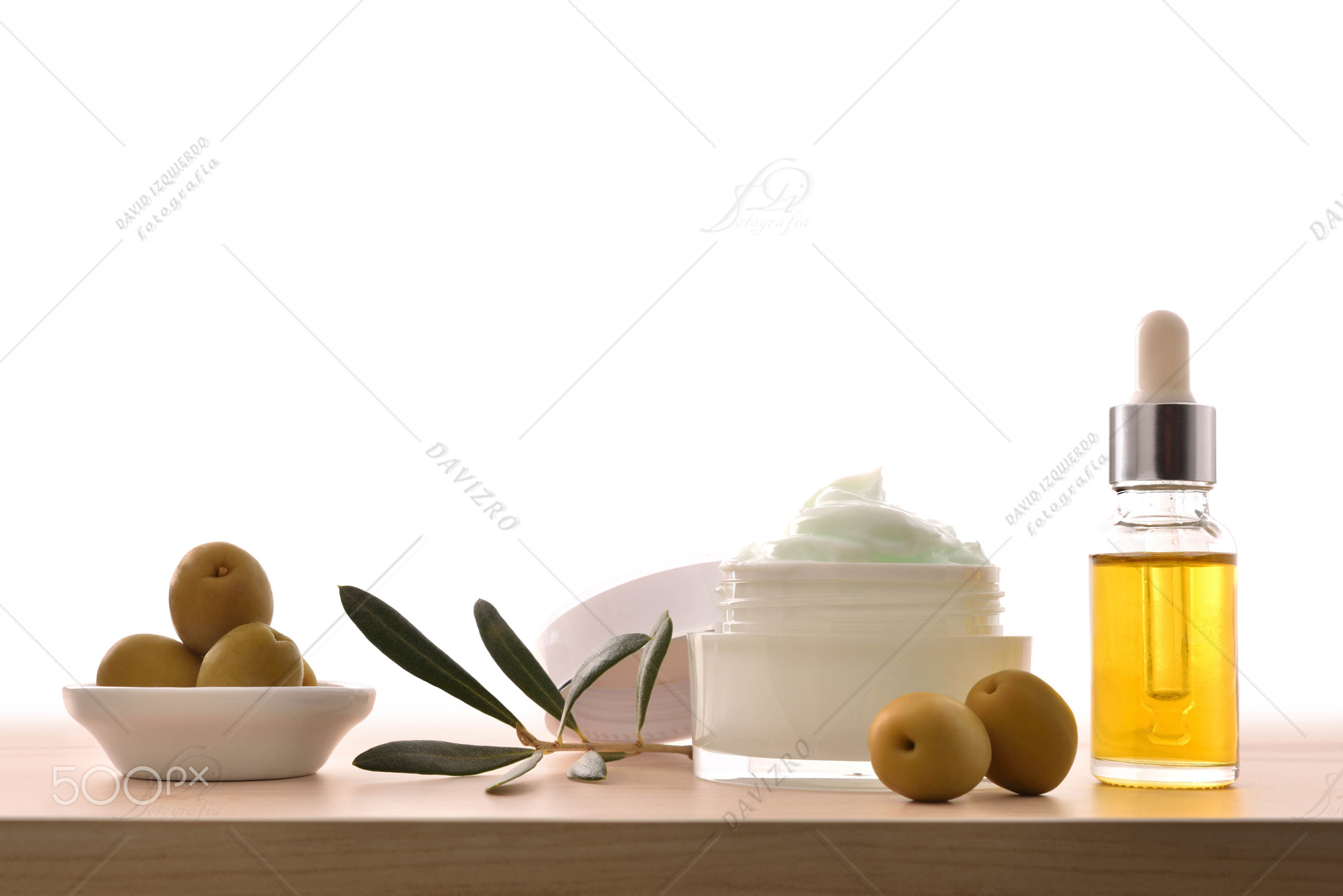 Olive moisturizing cream and serum on wood isolated front