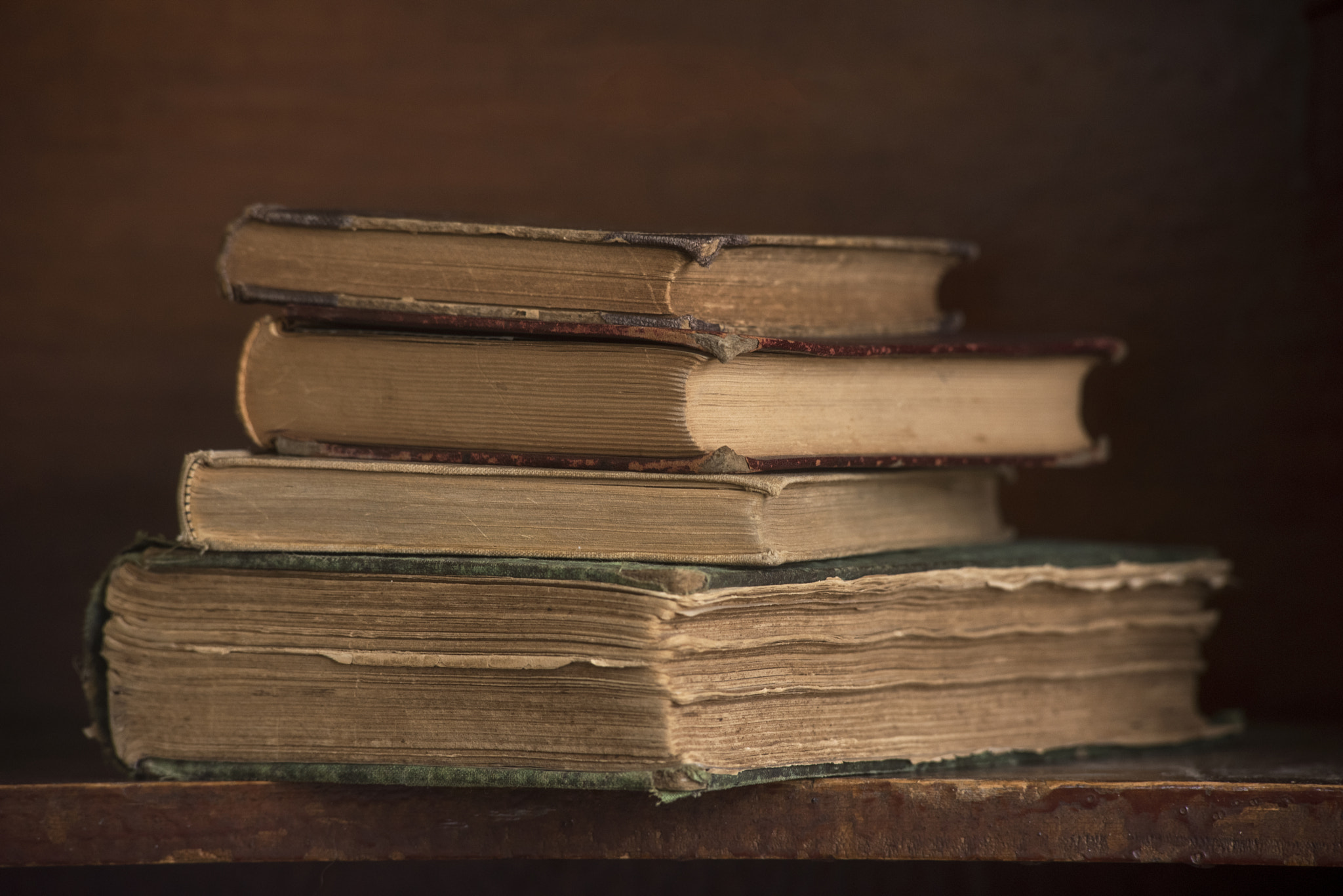 Antique Books Stacked on a Shelf