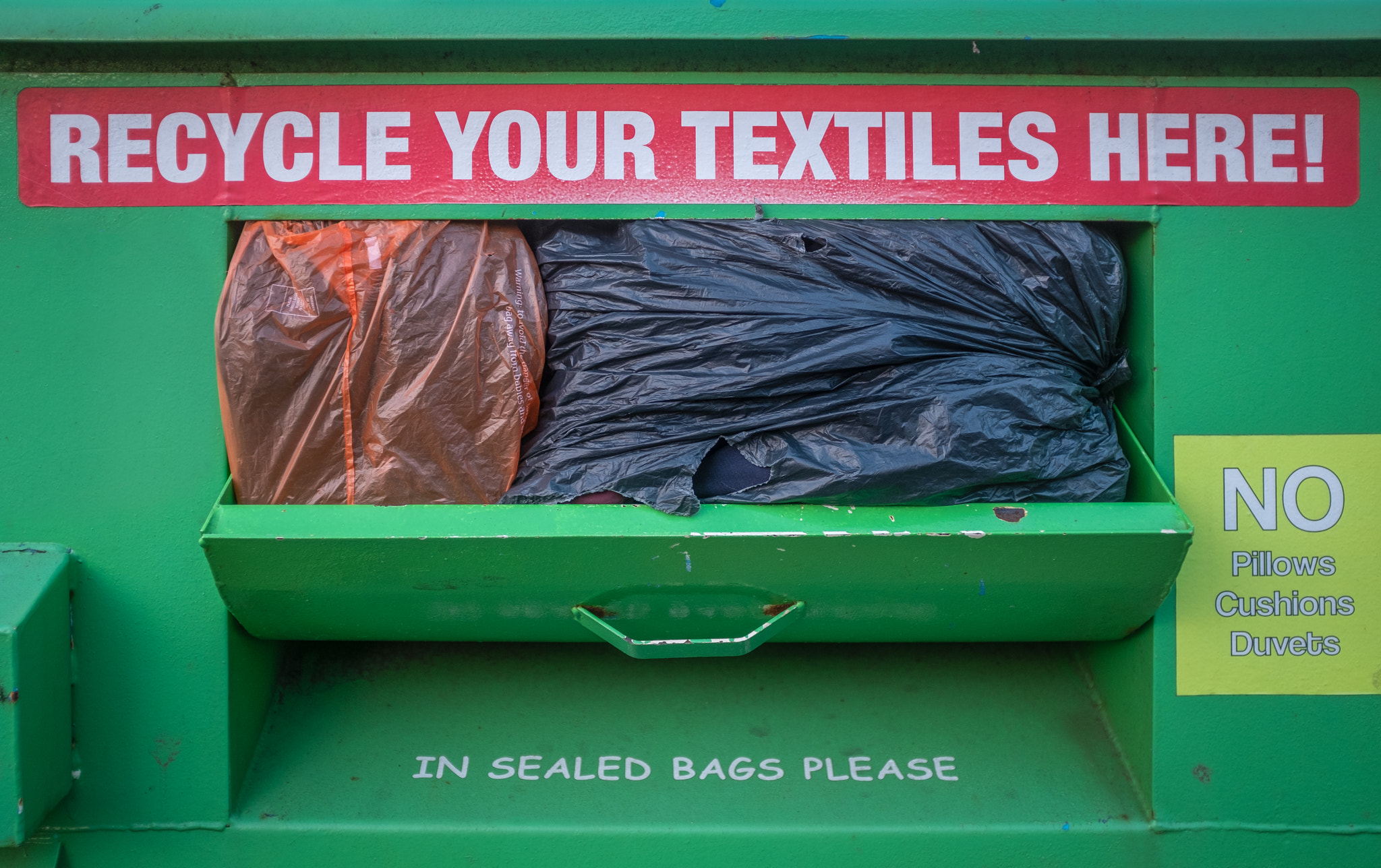 Overflowing Textile Recycling Bin