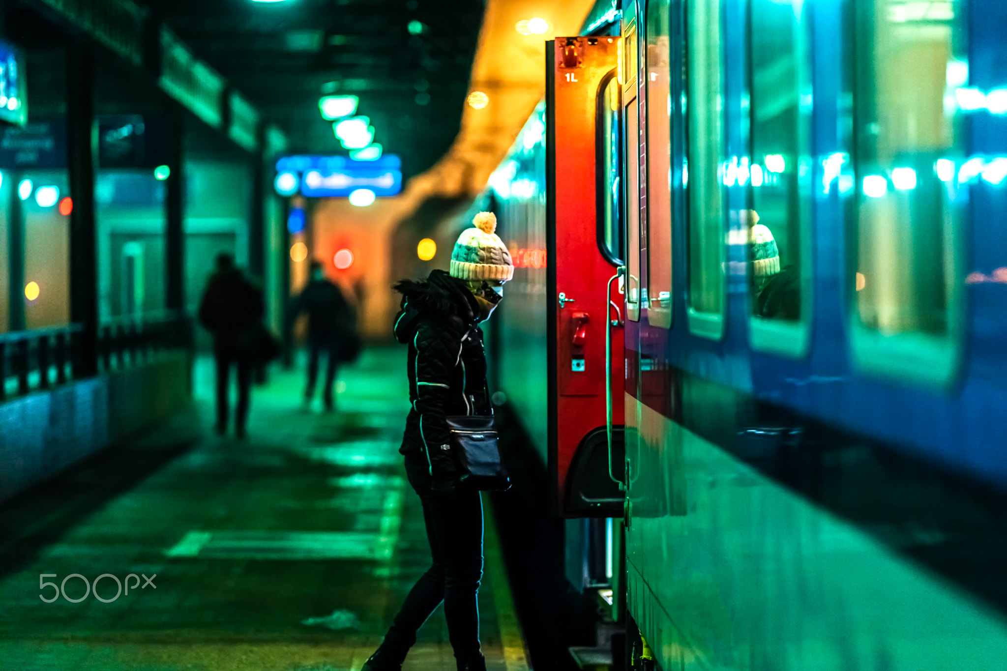 woman boarding a night train at the station