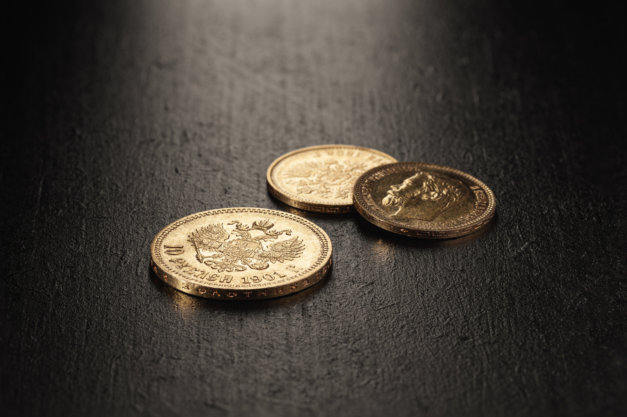 Numismatics. Old collectible coins made of gold on a wooden table.