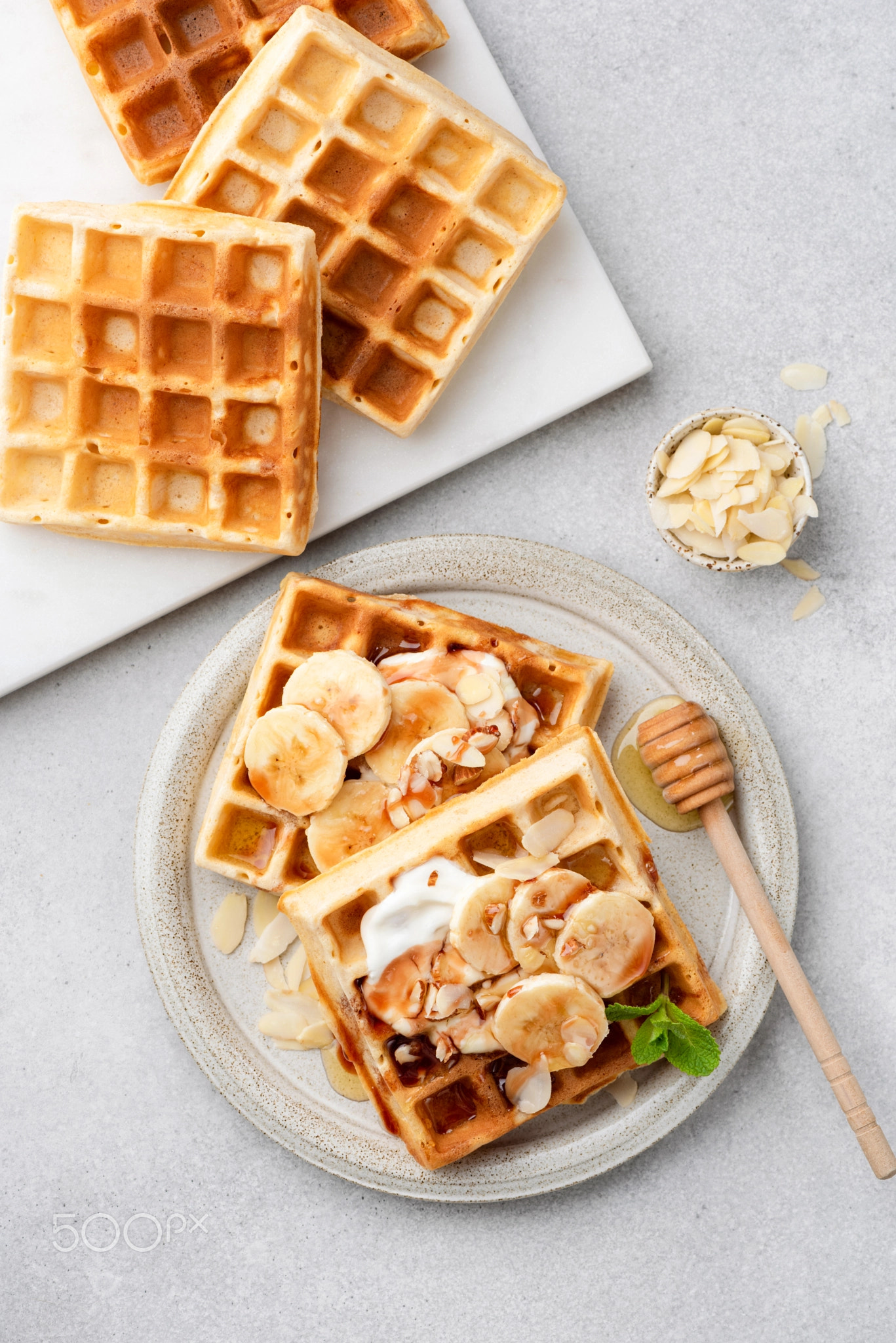 Sweet belgian waffles with cream, banana and honey