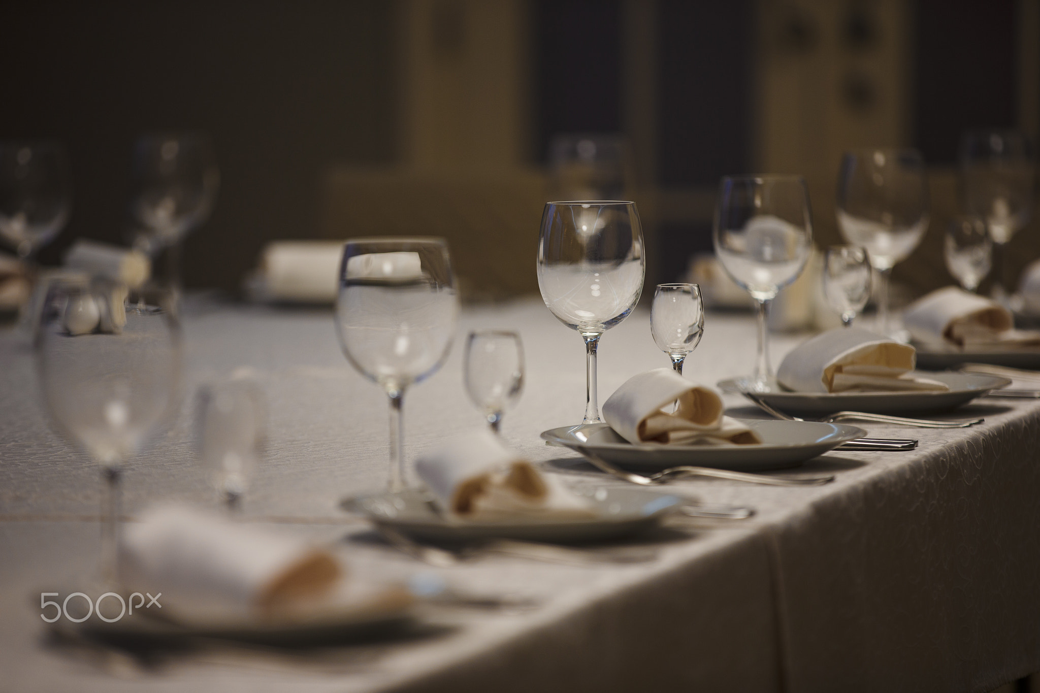 Row of place settings on table for a wedding reception