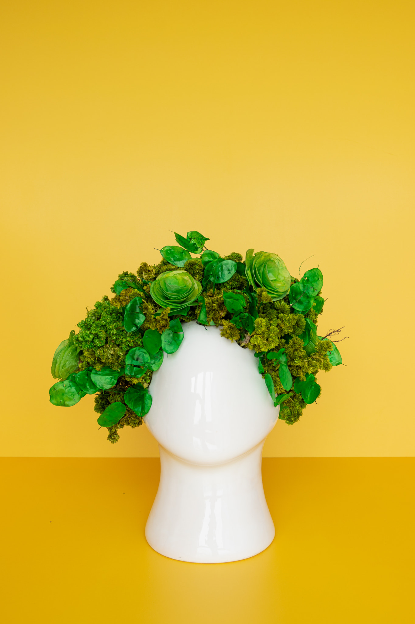 Flower arrangement with dried red flowers with head shaped pot