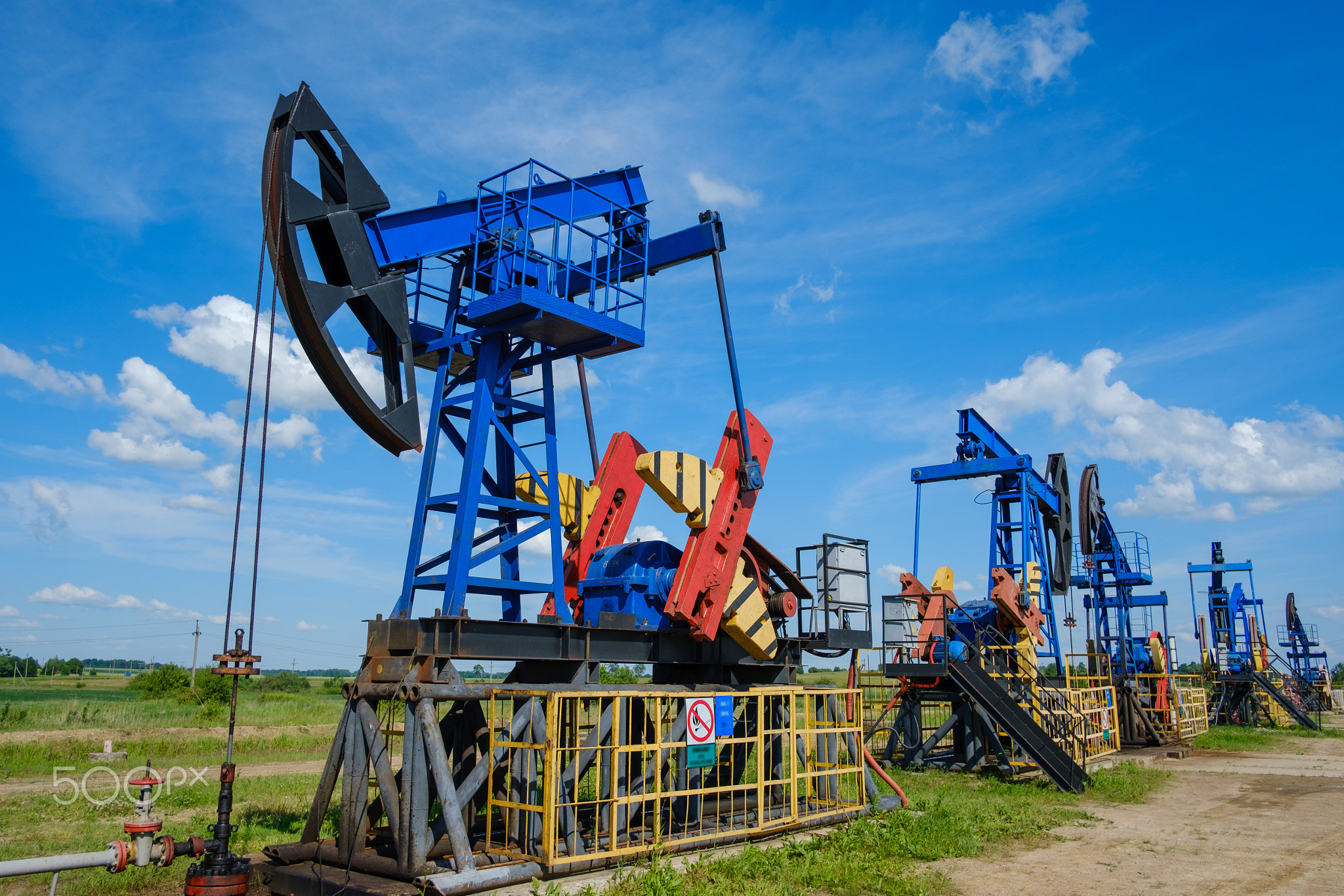 Oil pumps against cloudy sky