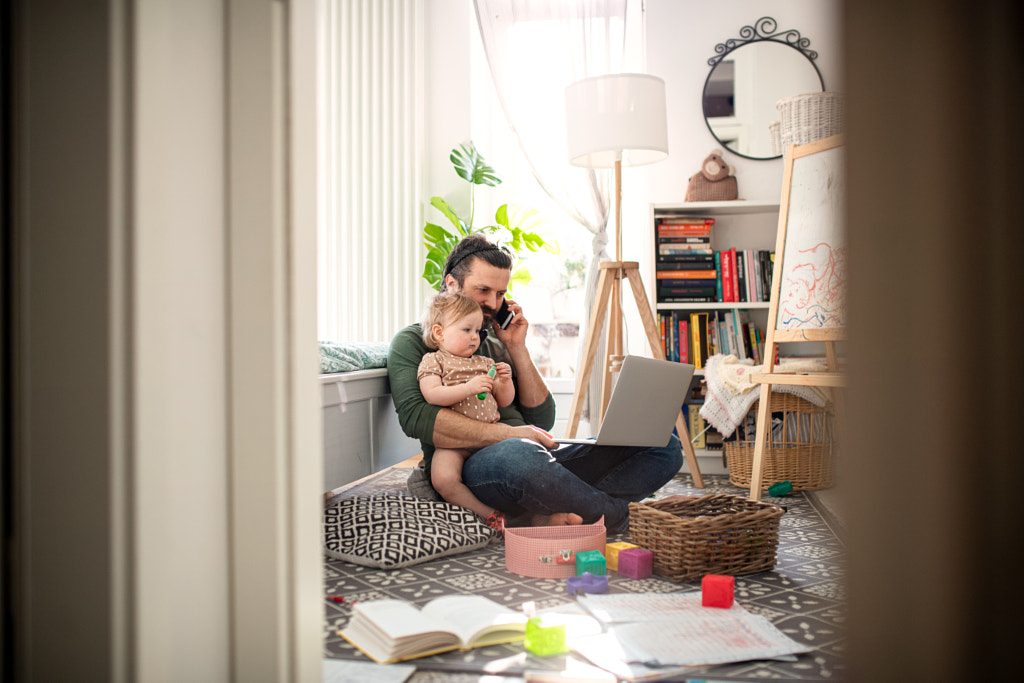 Father working with small toddler daughter in bedroom home office by Jozef Polc on 500px.com