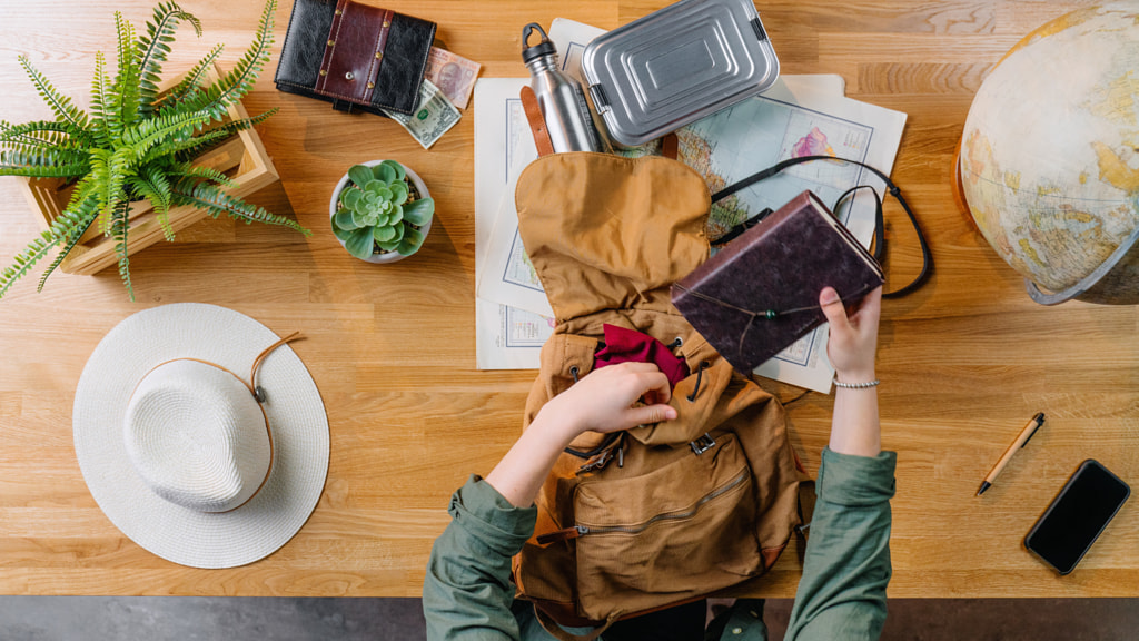 Top view of young woman packing for vacation trip holiday, desktop by Jozef Polc on 500px.com