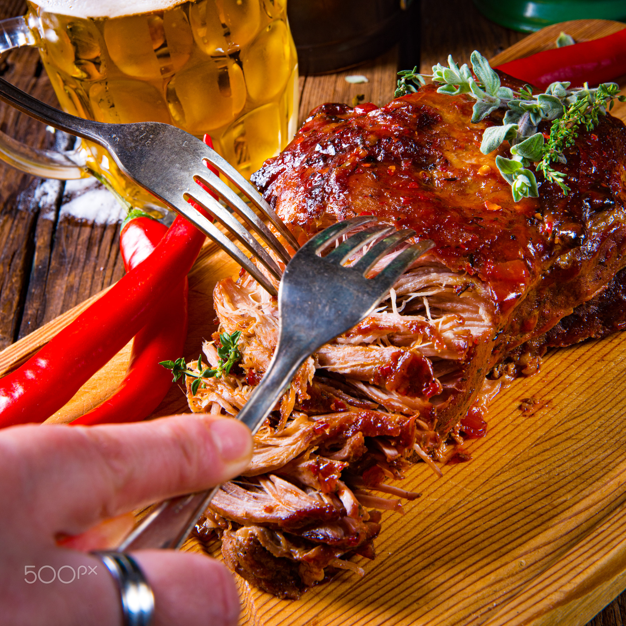 Pulled pork out of the oven with beer sauce