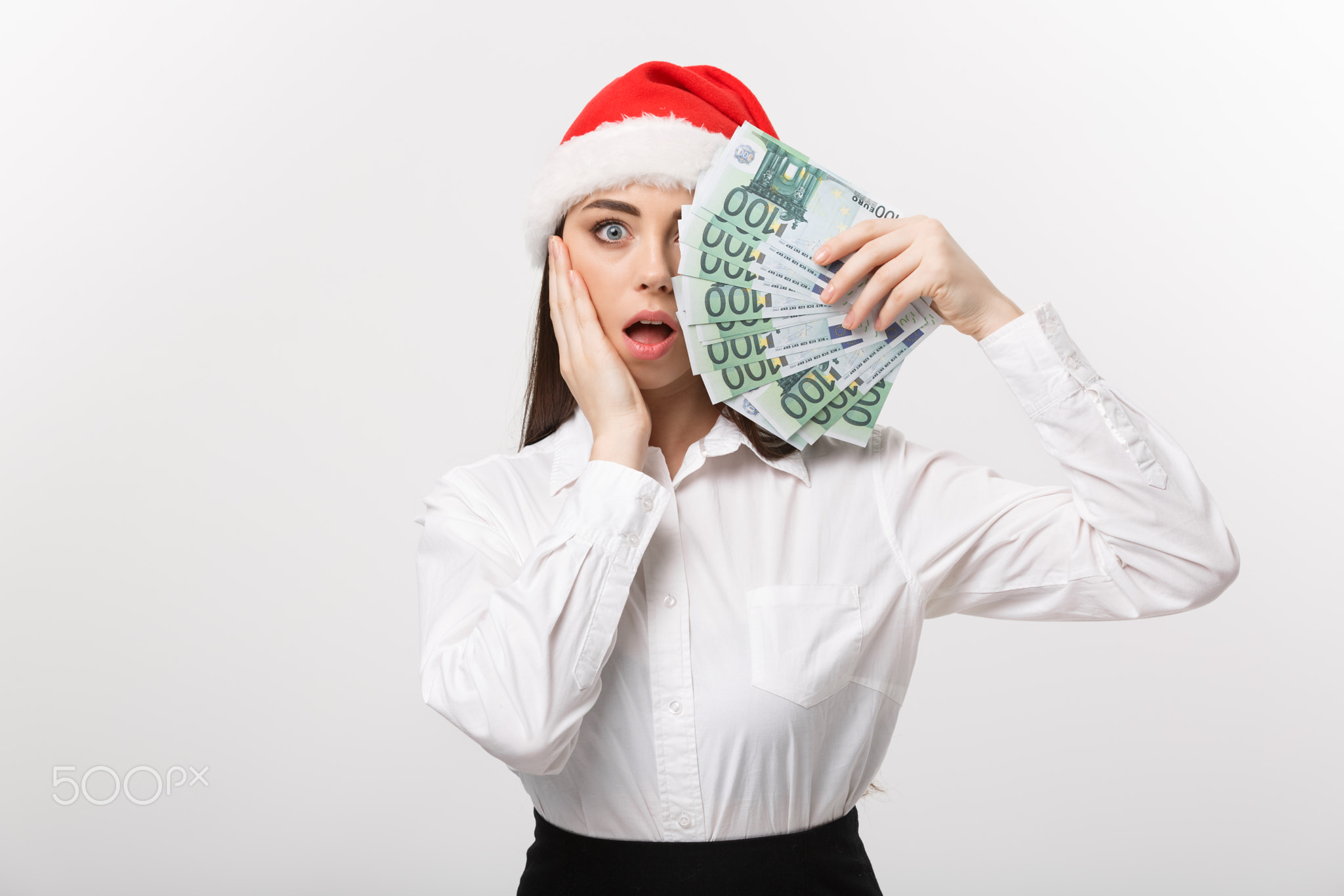 Christmas and finance concept - Young business woman showing money