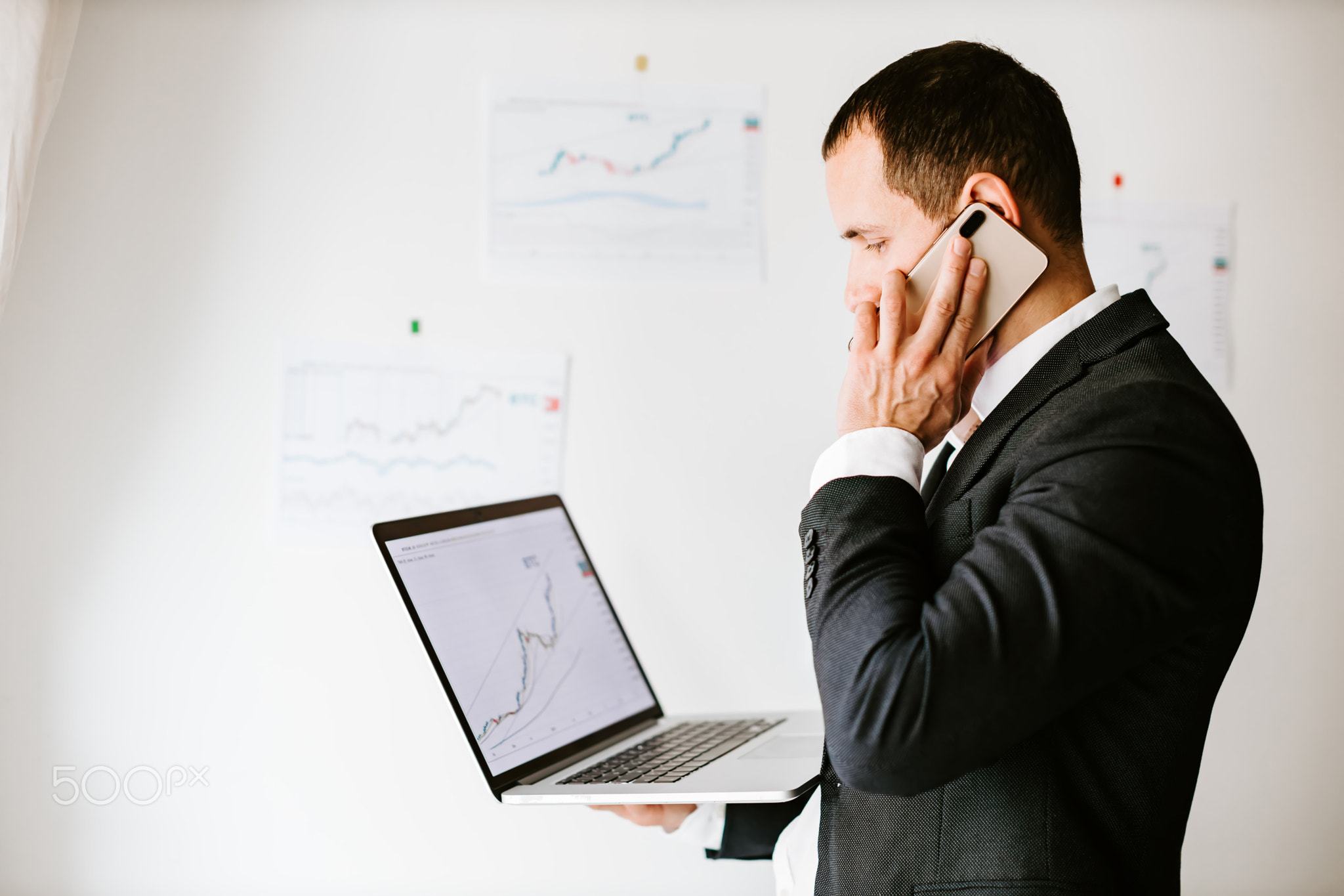concentrated investment stock broker talking on phone in office