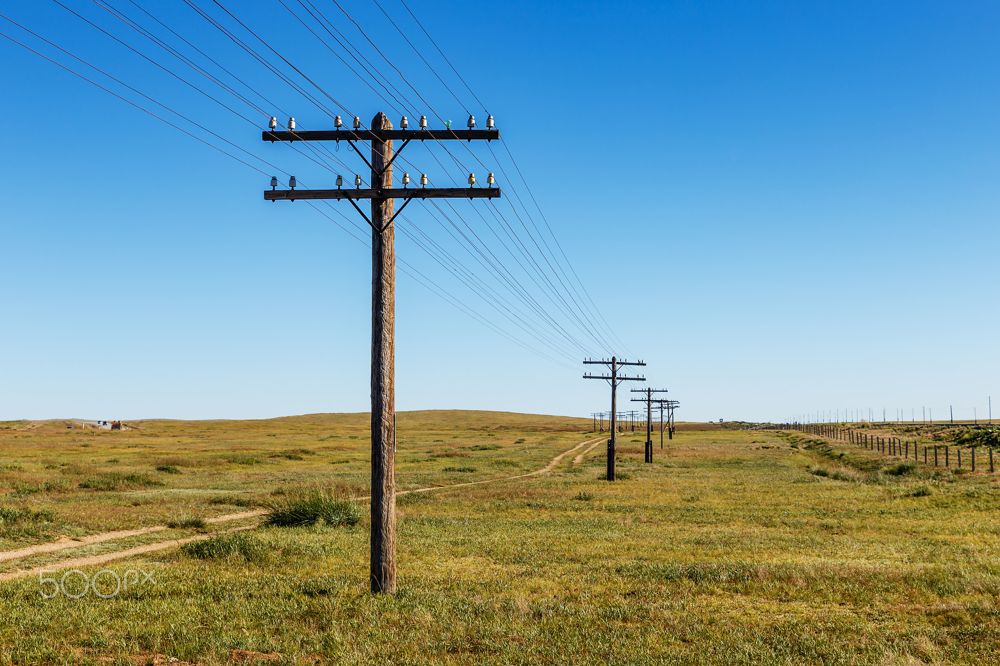 overhead line on wooden supports in the Mongolian steppe