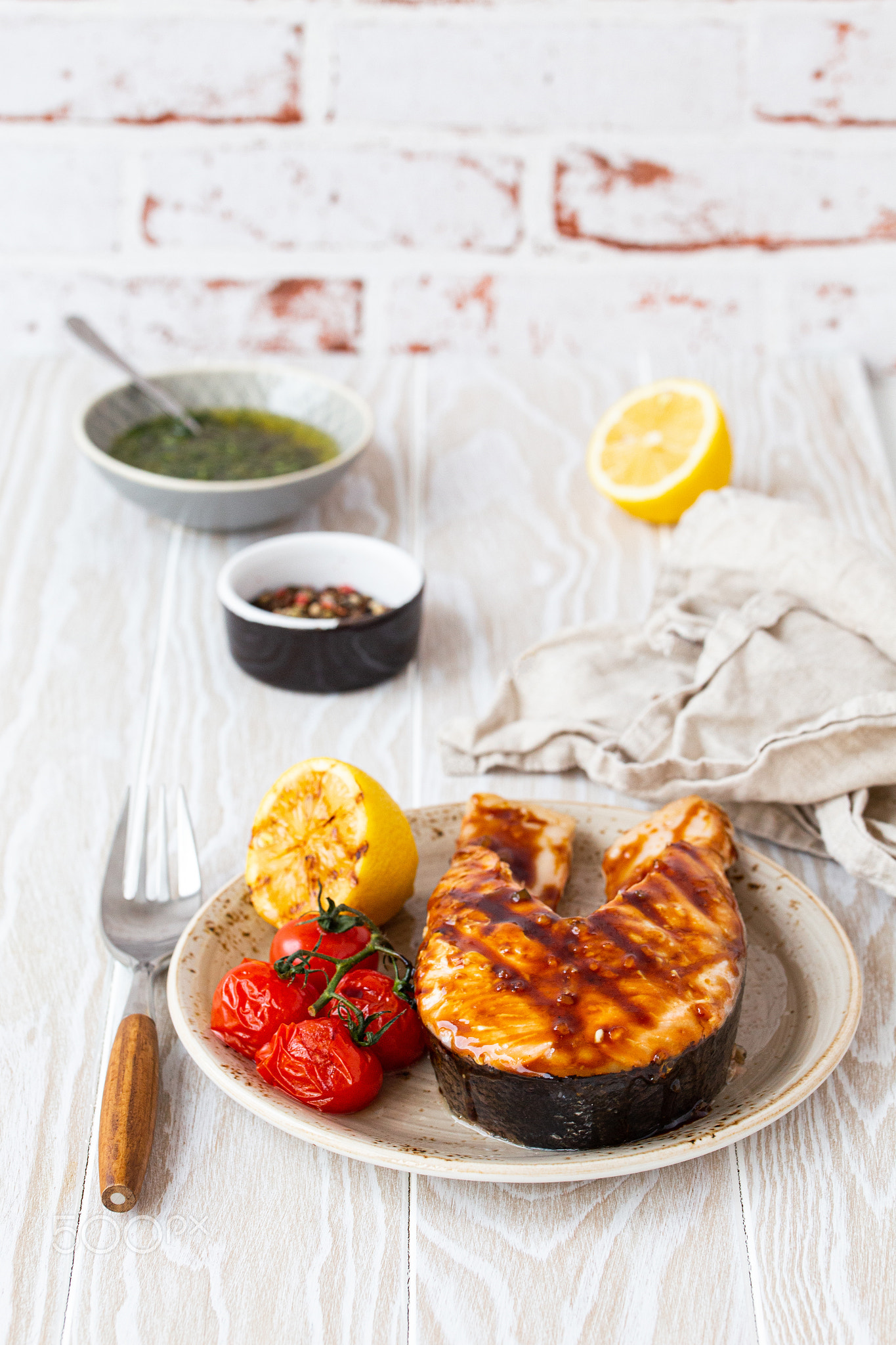 Grilled salmon steak on white wooden background