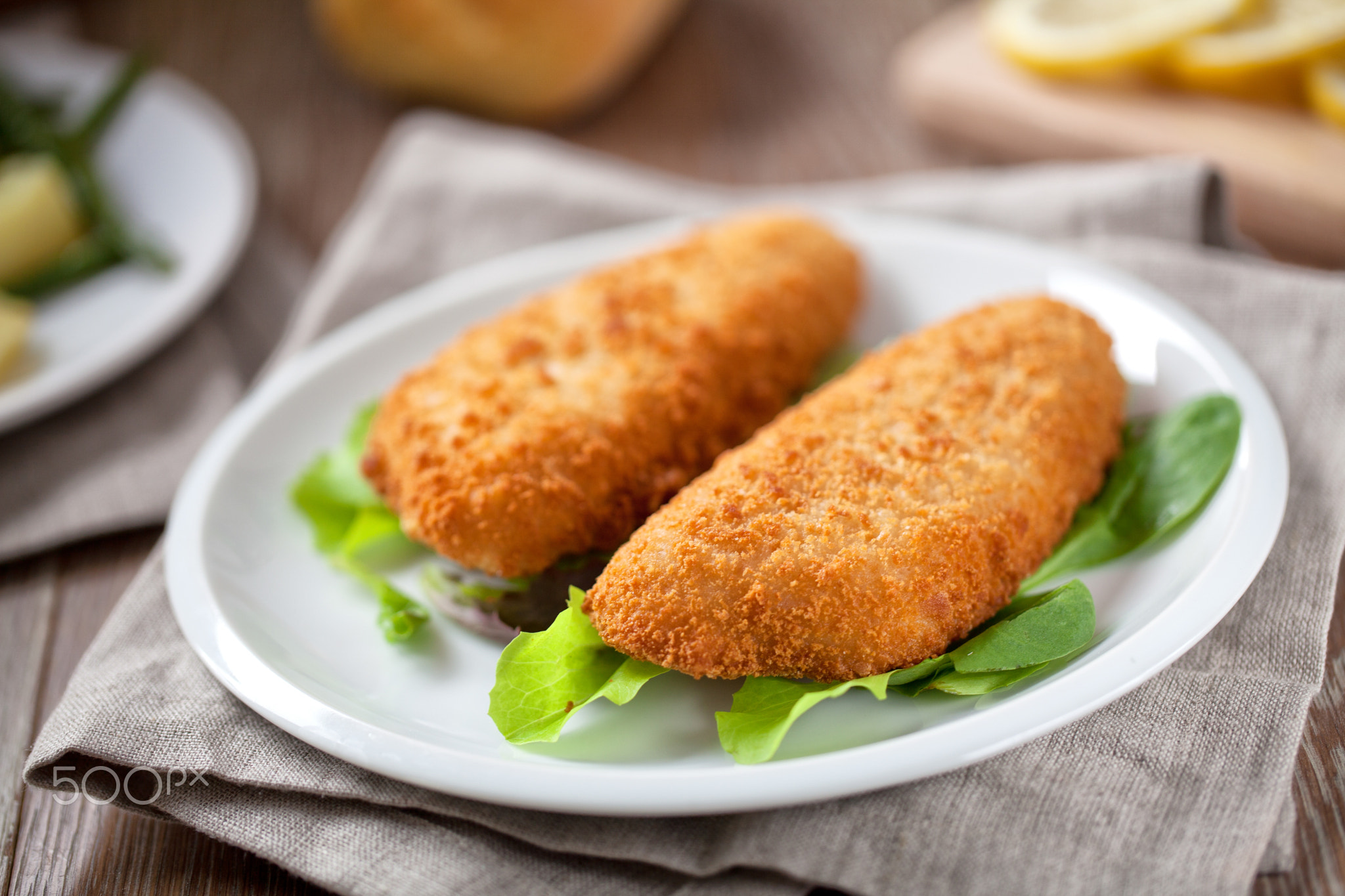 Breaded Fish Fillet With Salad. High quality photo.