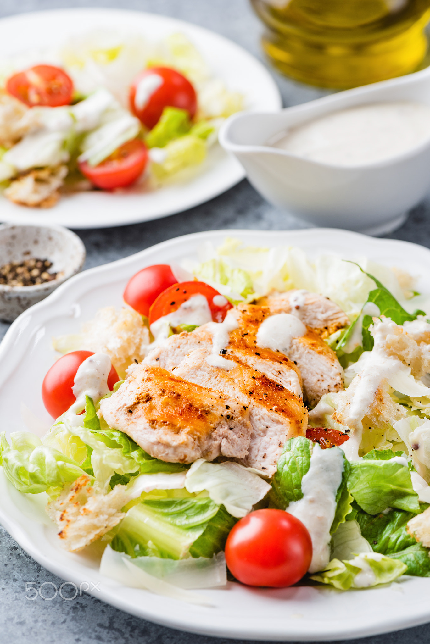 Caesar salad with grilled chicken and sauce