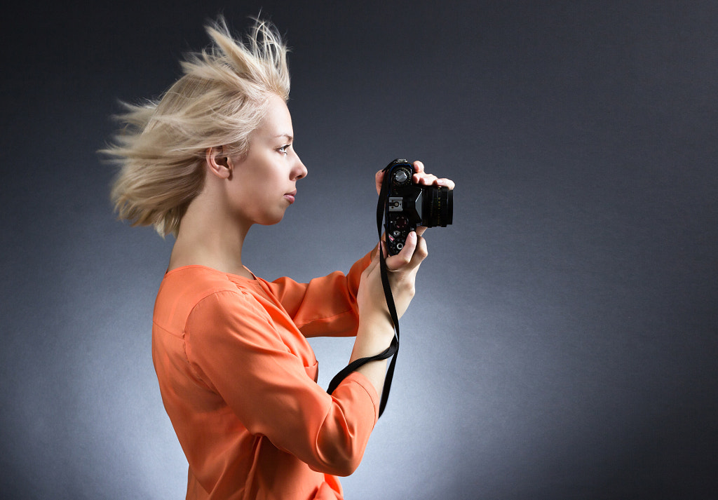 A girl photographer with a photo camera on a dark background.. by Refat Mamutov on 500px.com