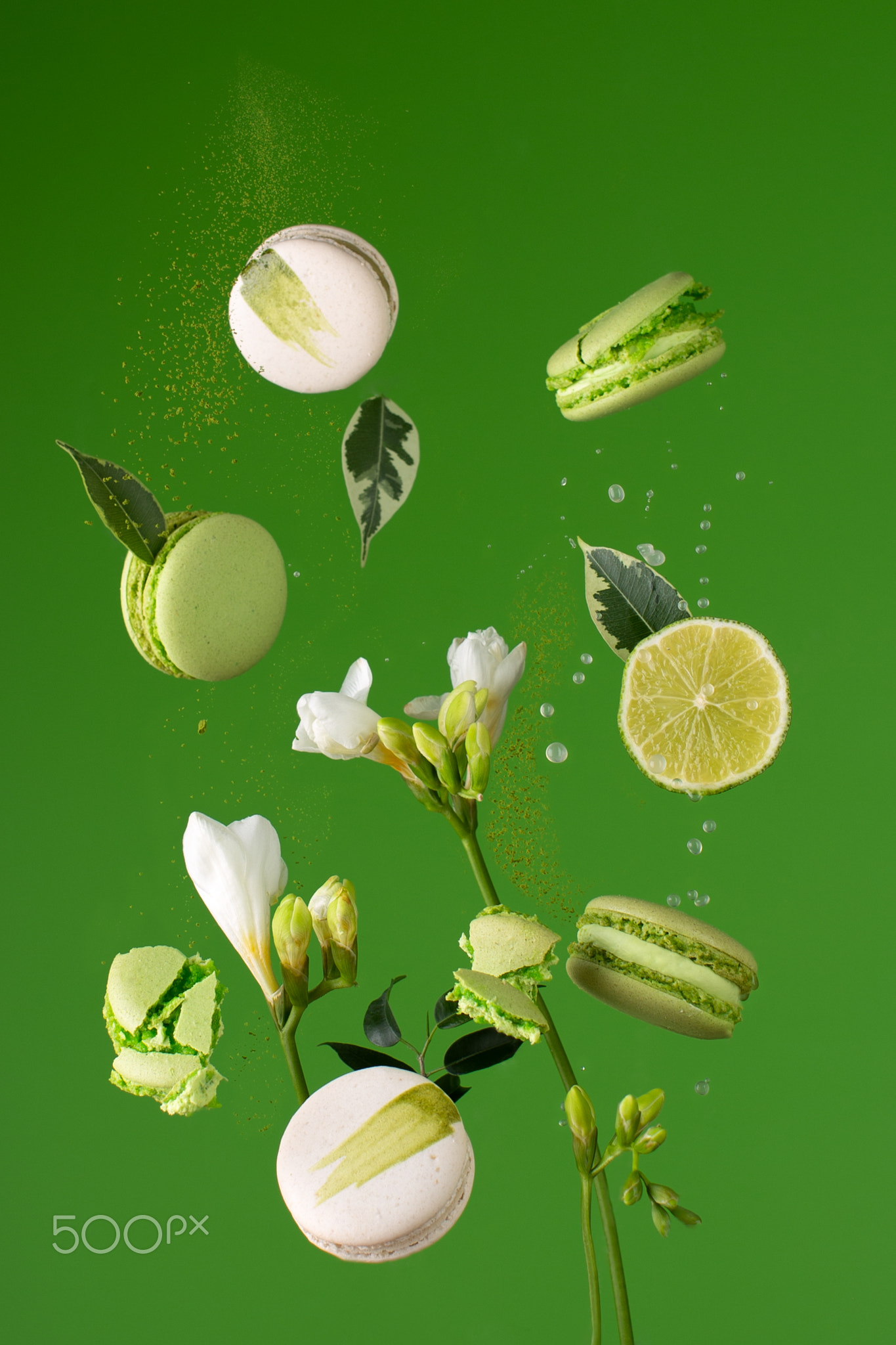 French green macaroons flying with gentle flowers,lime,drops of juice