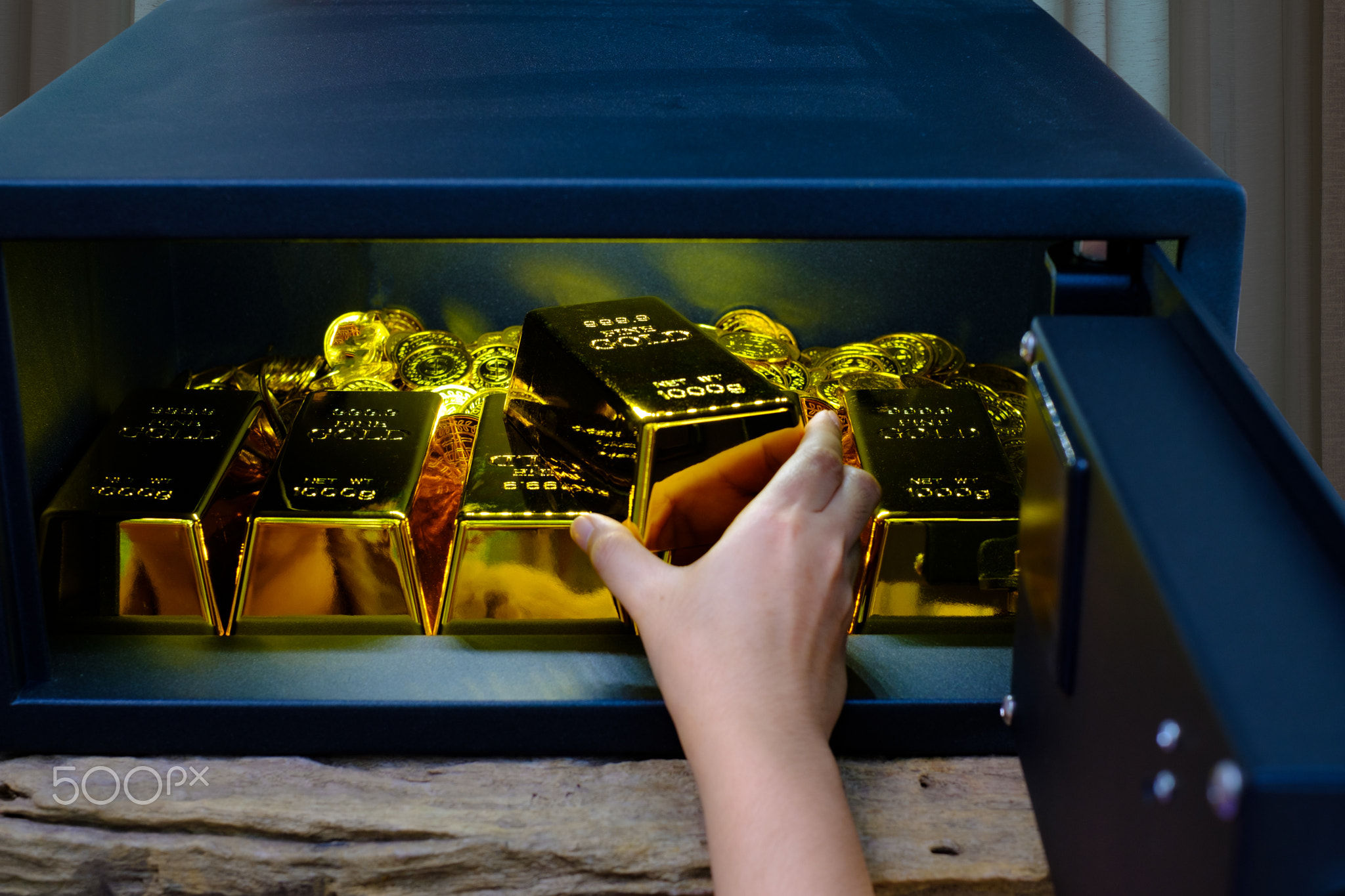 Hand open electronics steel safe box full of coins stack and gold bar