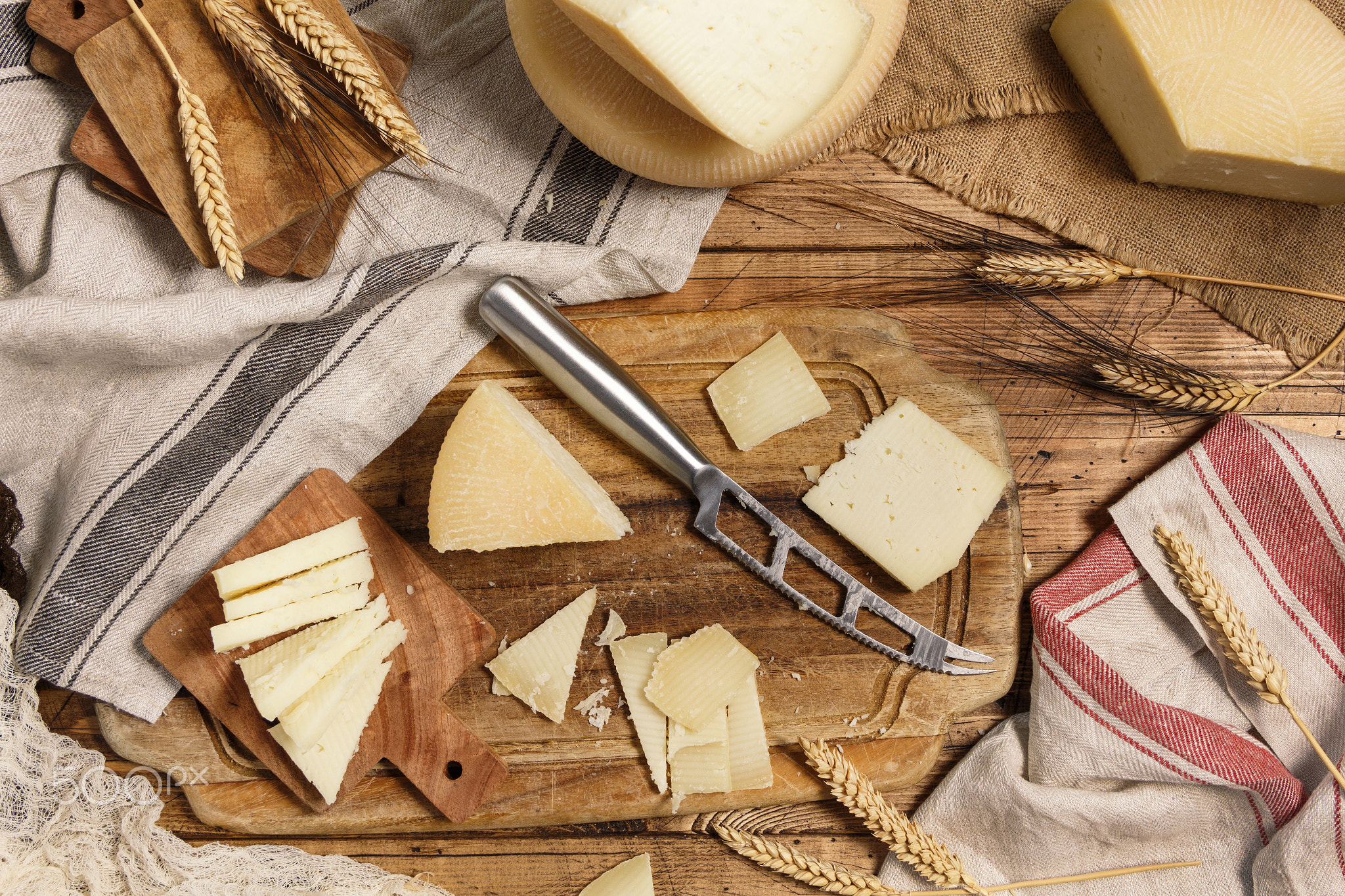 Pieces of  fresh homemade cheese on a wooden board with a knife