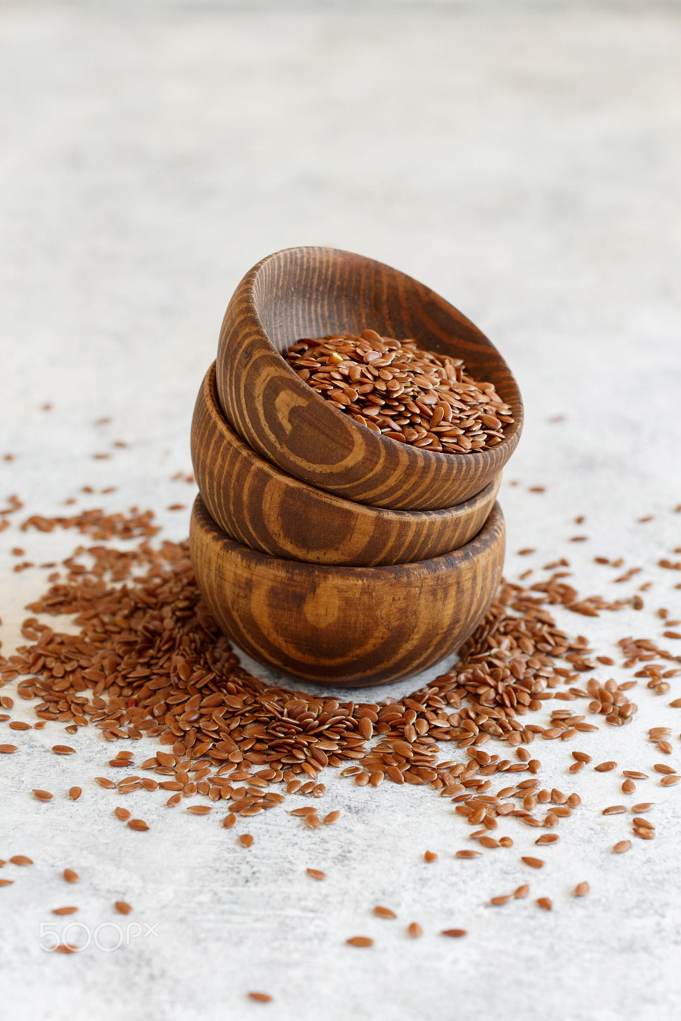Raw Flax seeds in a bowl: Raw Flax seeds in a wooden bowl close up