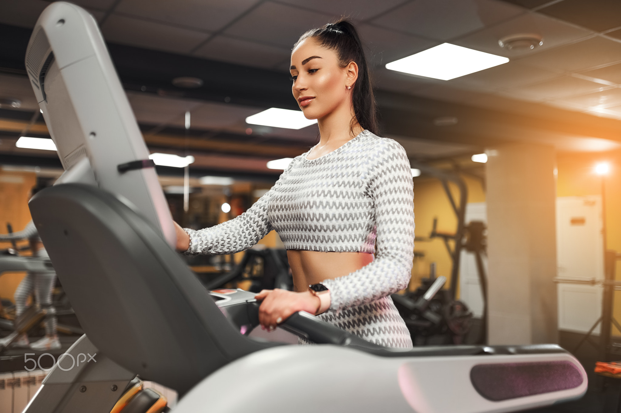 Young healthy woman cardio on a treadmill at the gym