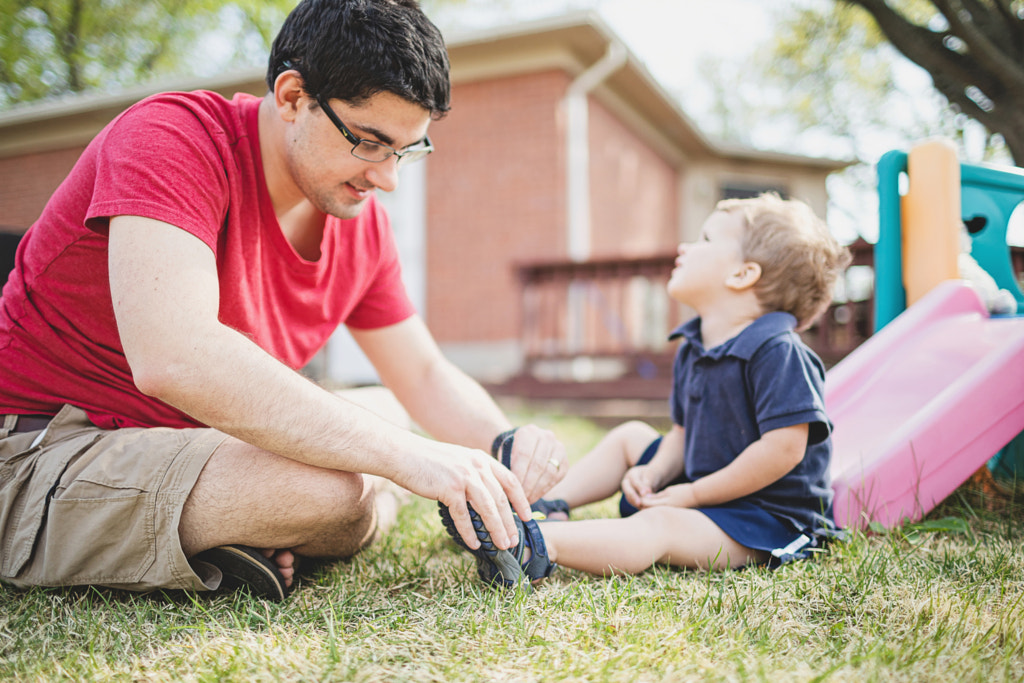 Father Putting on Toddler Son's Shoes, St. Louis, MO, USA by Nadia M on 500px.com