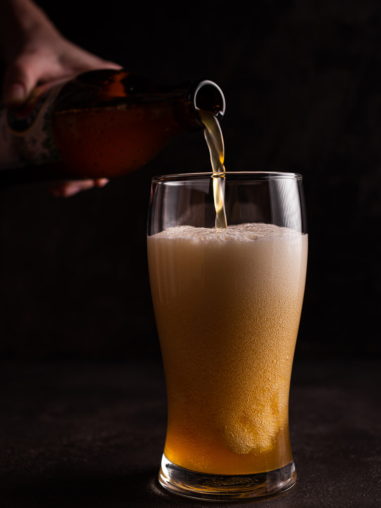 Beer is poured into a glass by Tati Honey on 500px.com