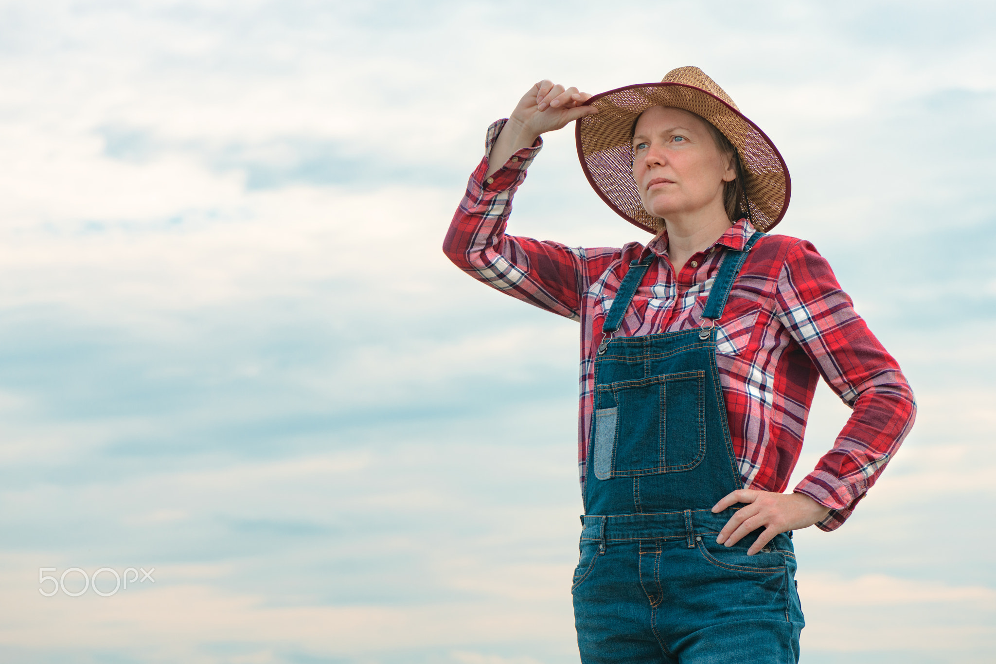 Portrait of concerned female farmer agronomist outdoors