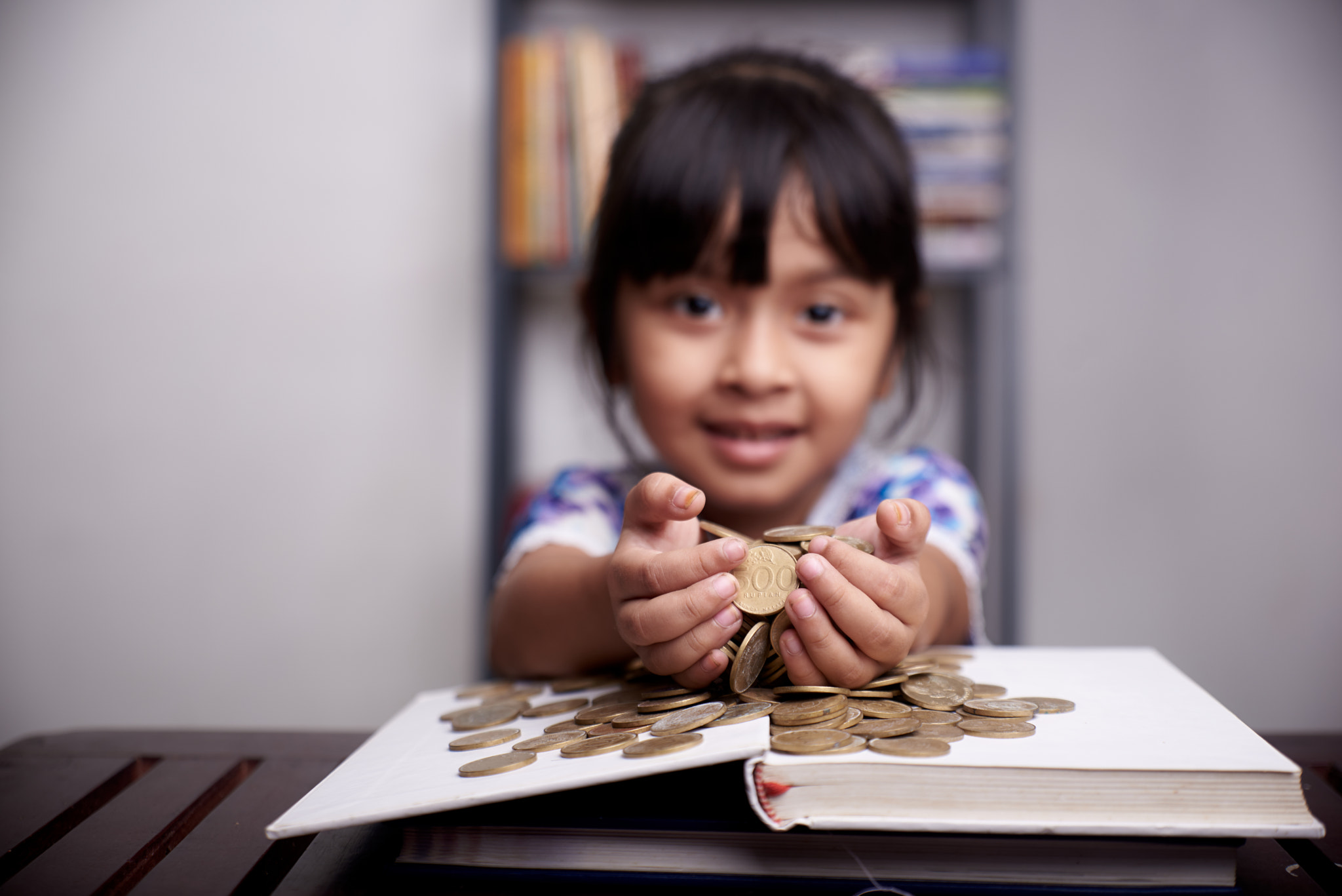 Little cute Girl is counting bunch of coins