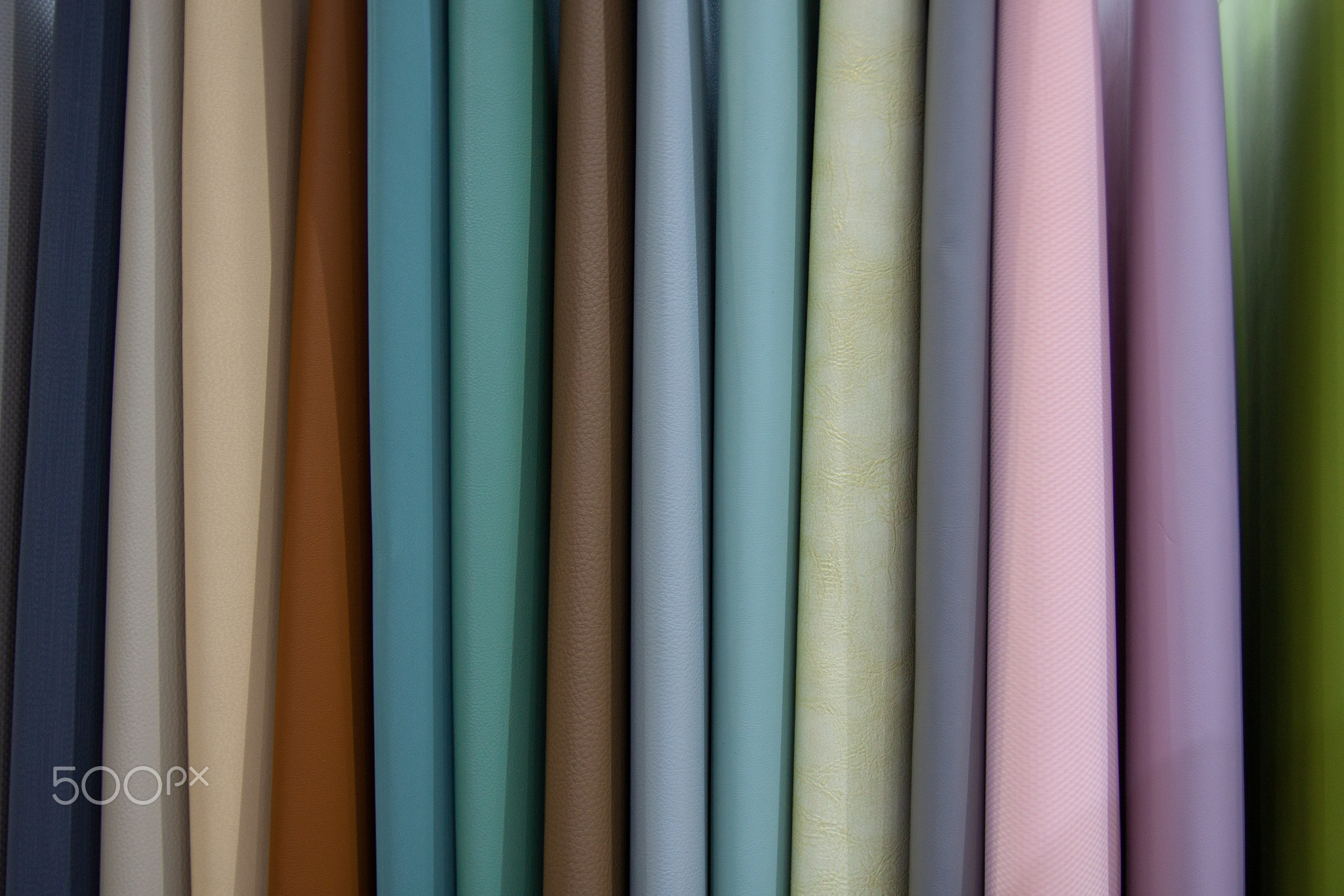 Various samples of colored leather material, colorful background, copy