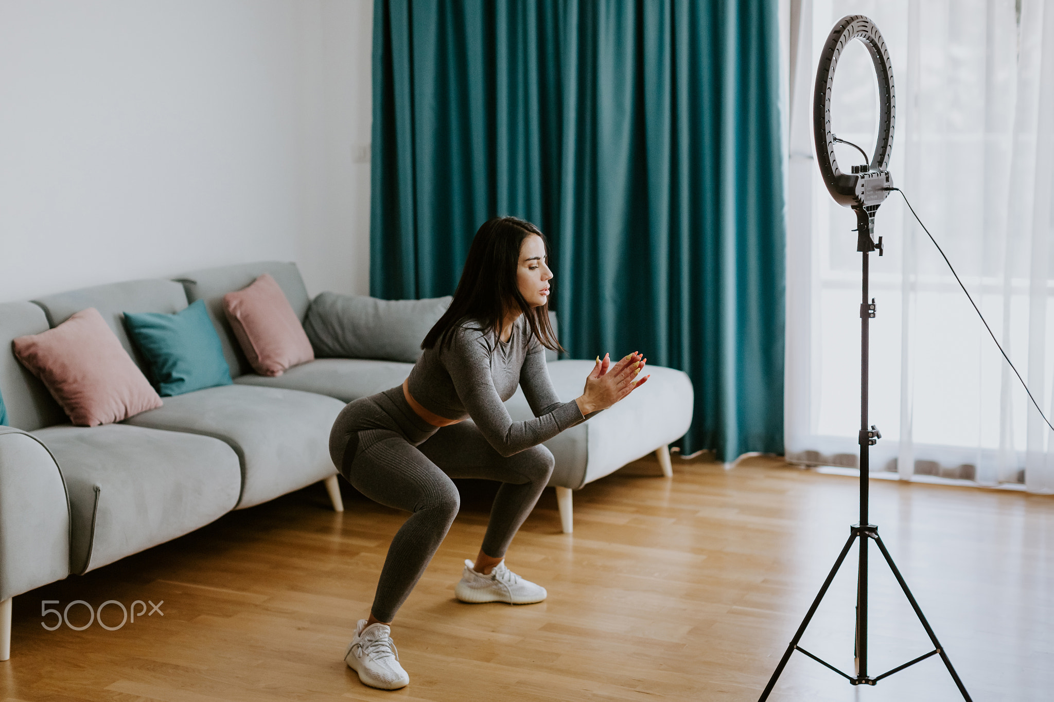 Virtual online fitness. Woman virtual workout at home living room
