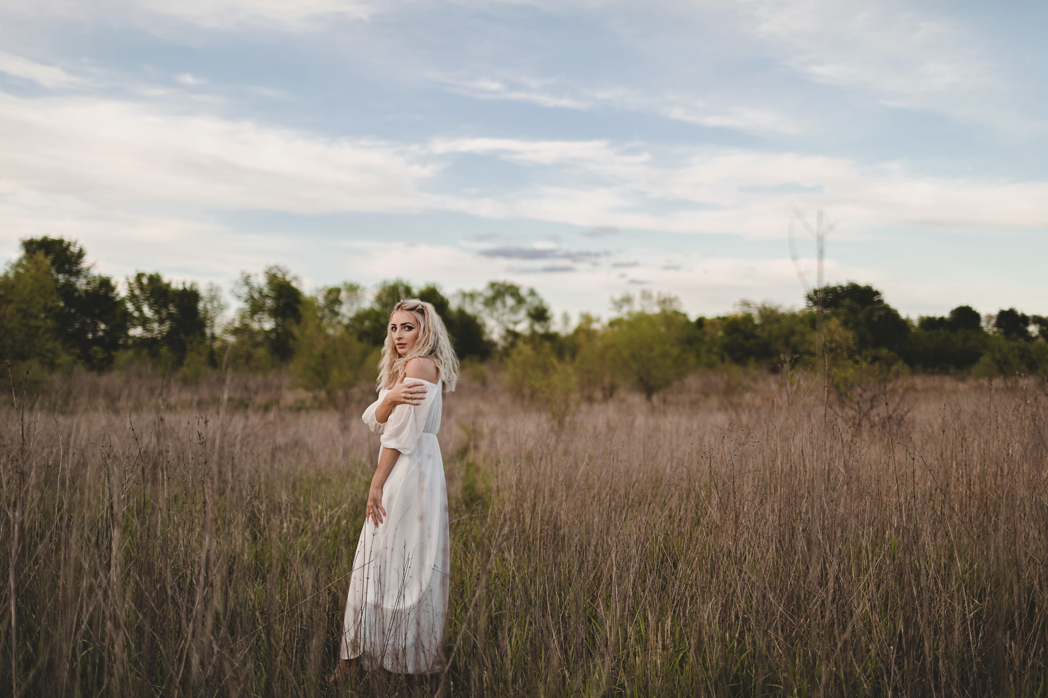 Young Woman in White Dress Stands in Field, St. Peters, MO, USA