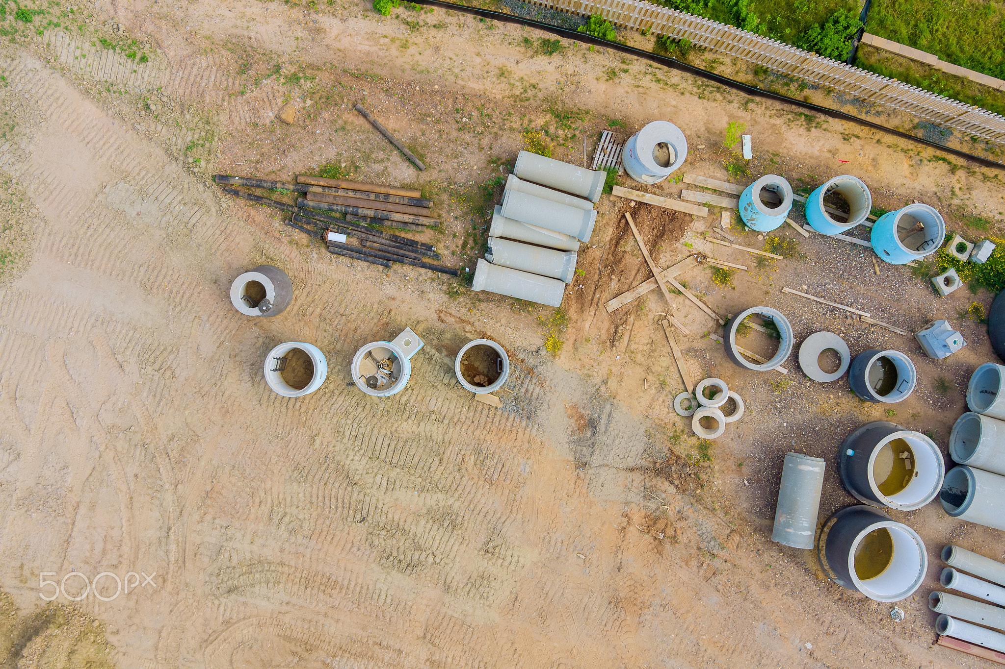 Water and sewage pipes stacked in construction site