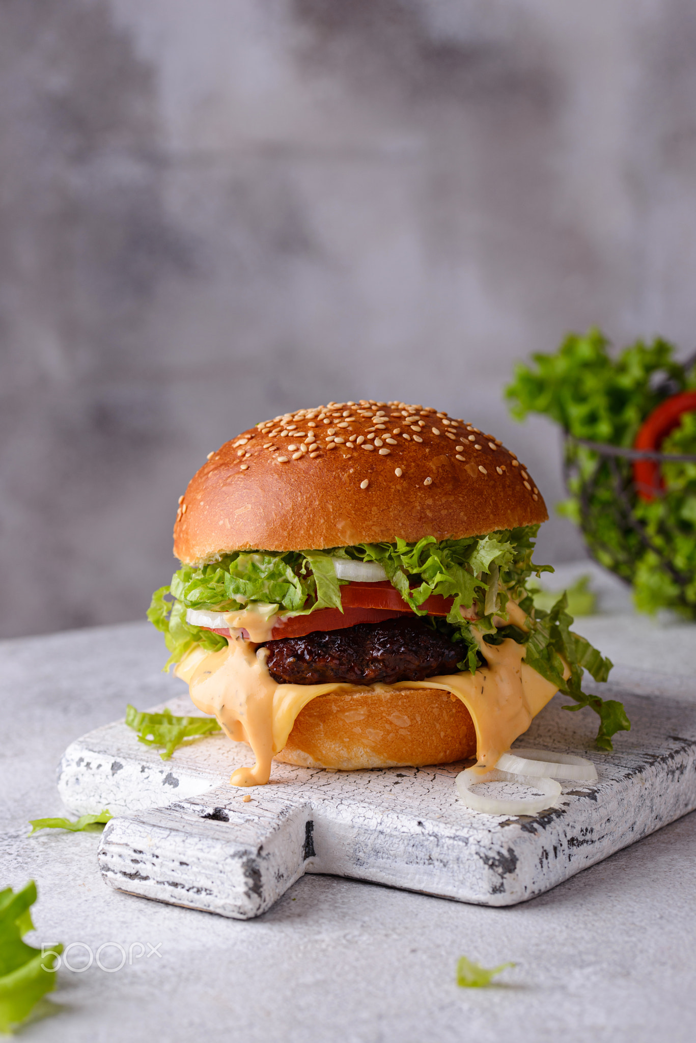 Cheeseburger with beef cutlet and vegetables