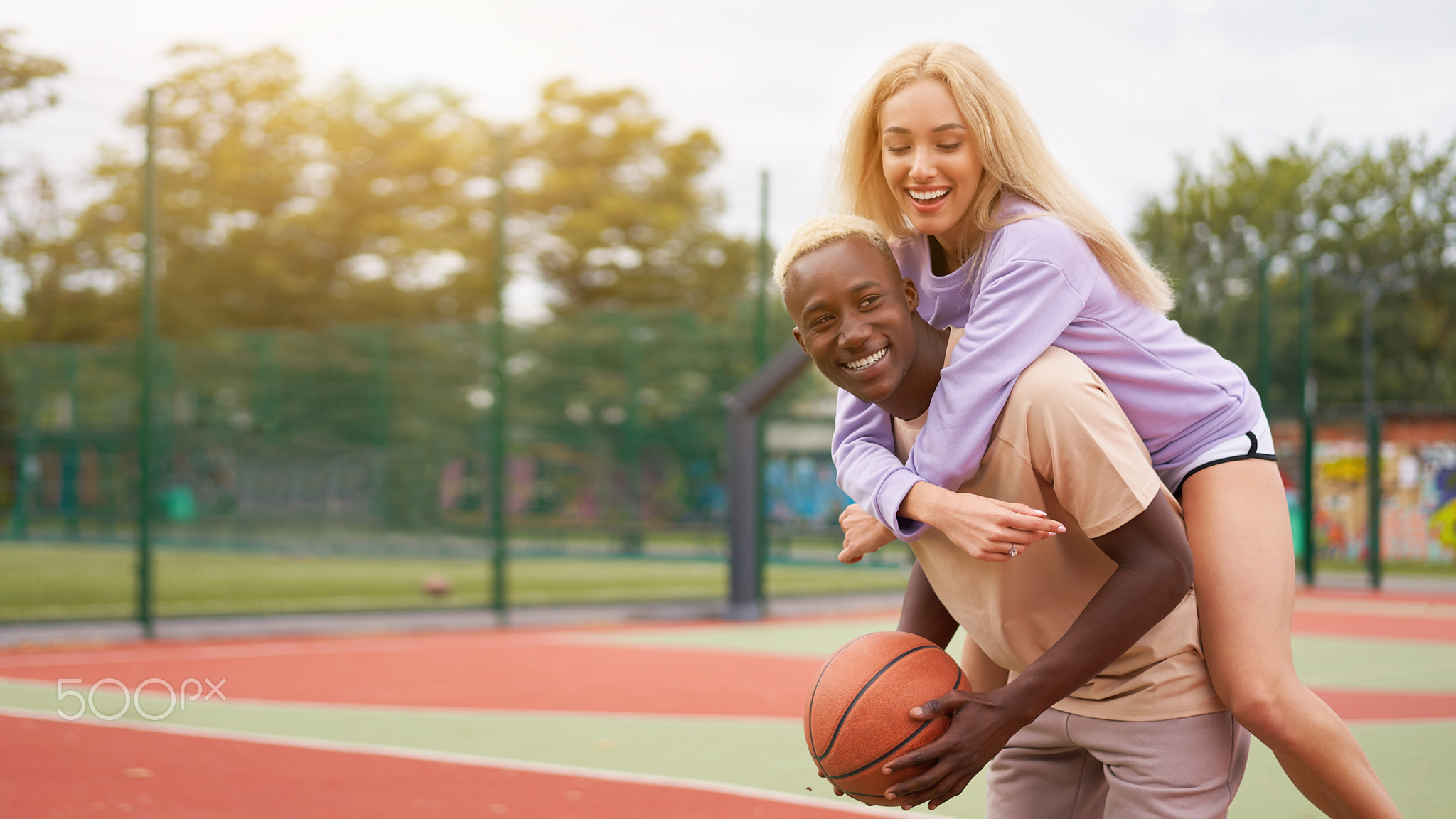 Basketball afro american man friends training caucasian woman