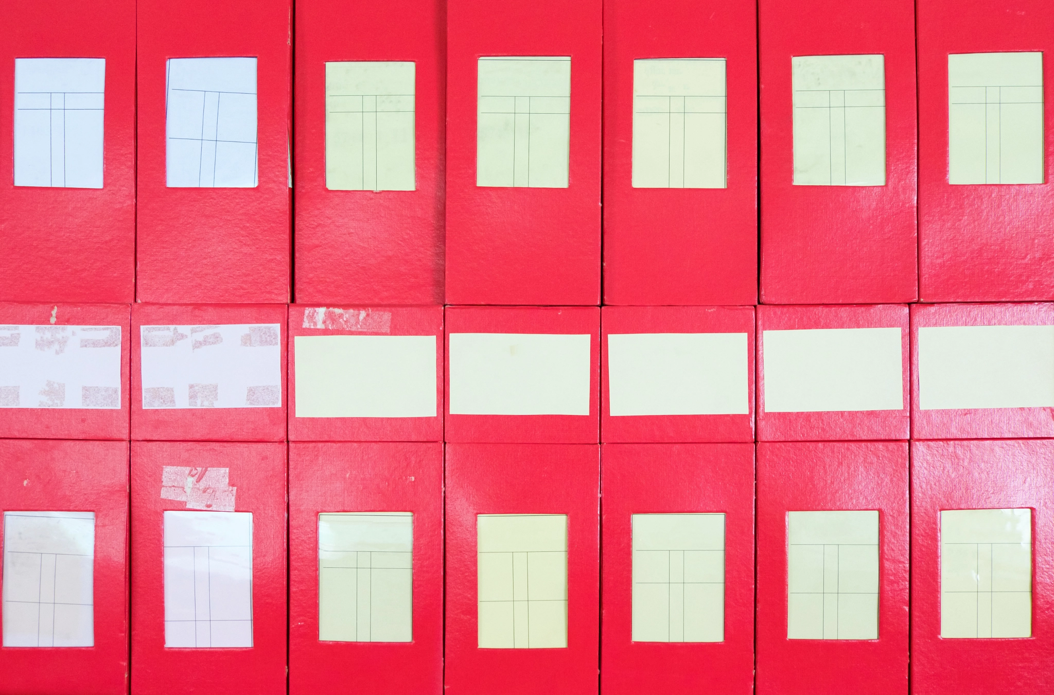 Red cardboard box pile with label to contain the document.