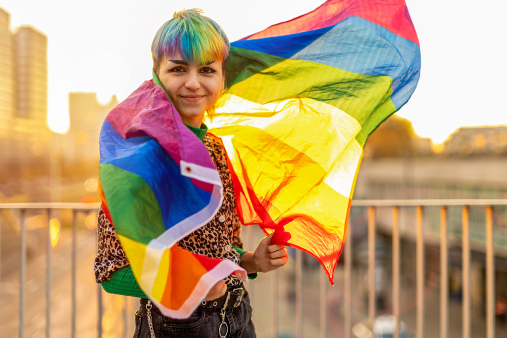 Portrait of a gender fluid person wearing rainbow flag by Edyta Pawlowska on 500px.com