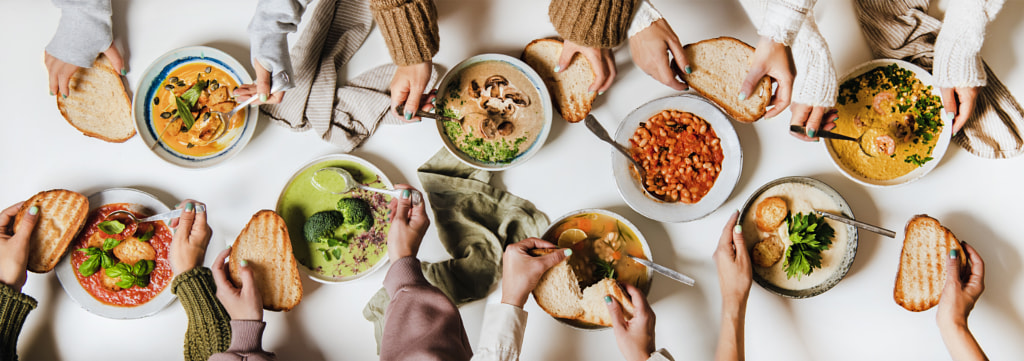 People eating various Autumn and Winter creamy vegan soups together by Anna Ivanova on 500px.com