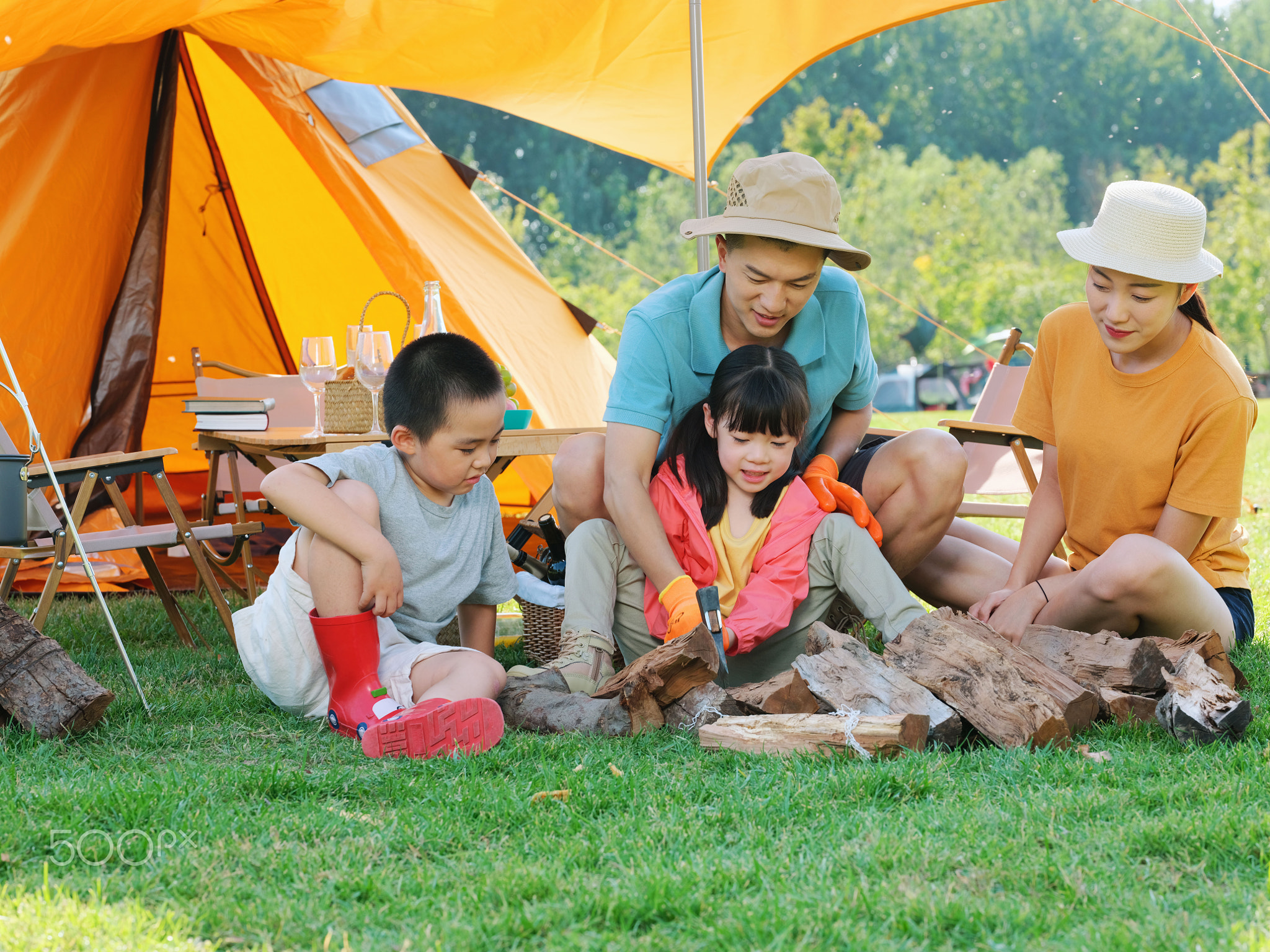 A Happy family of four camping outdoors