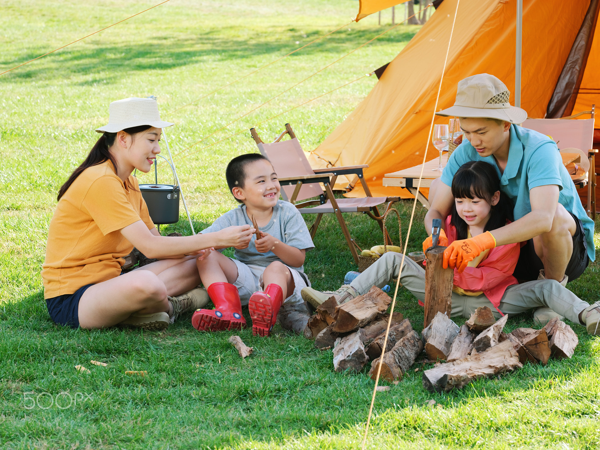 A Happy family of four camping outdoors