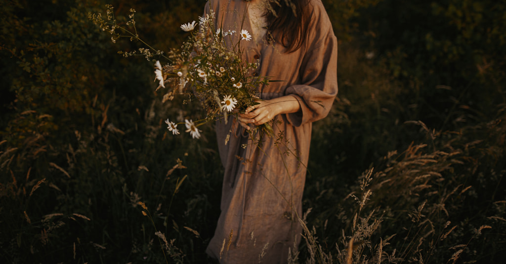 Beautiful woman in linen dress gathering wildflowers in summer meadow by Bogdan Sonjachnyj on 500px.com