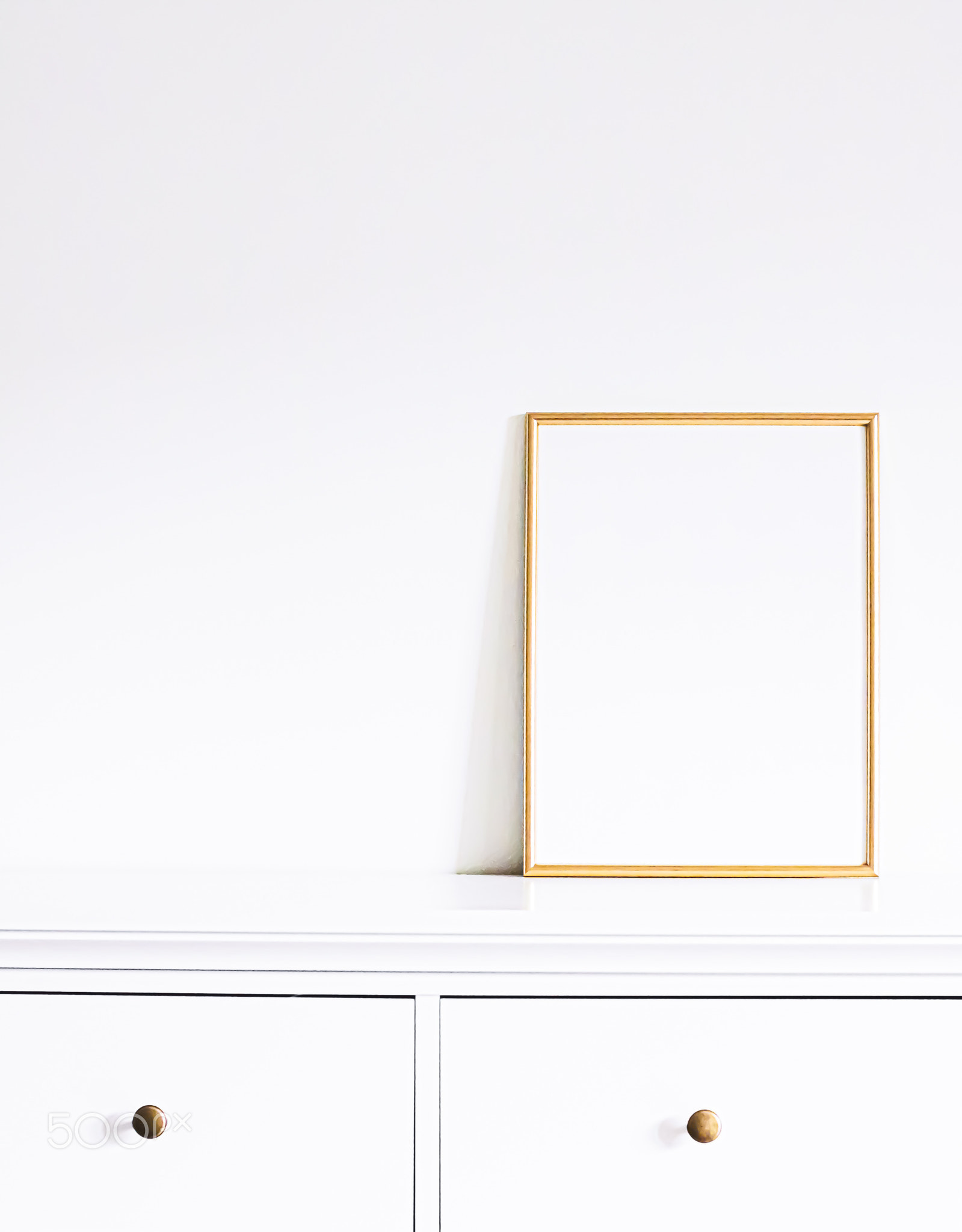 Golden frame on white furniture, luxury home decor and design for
