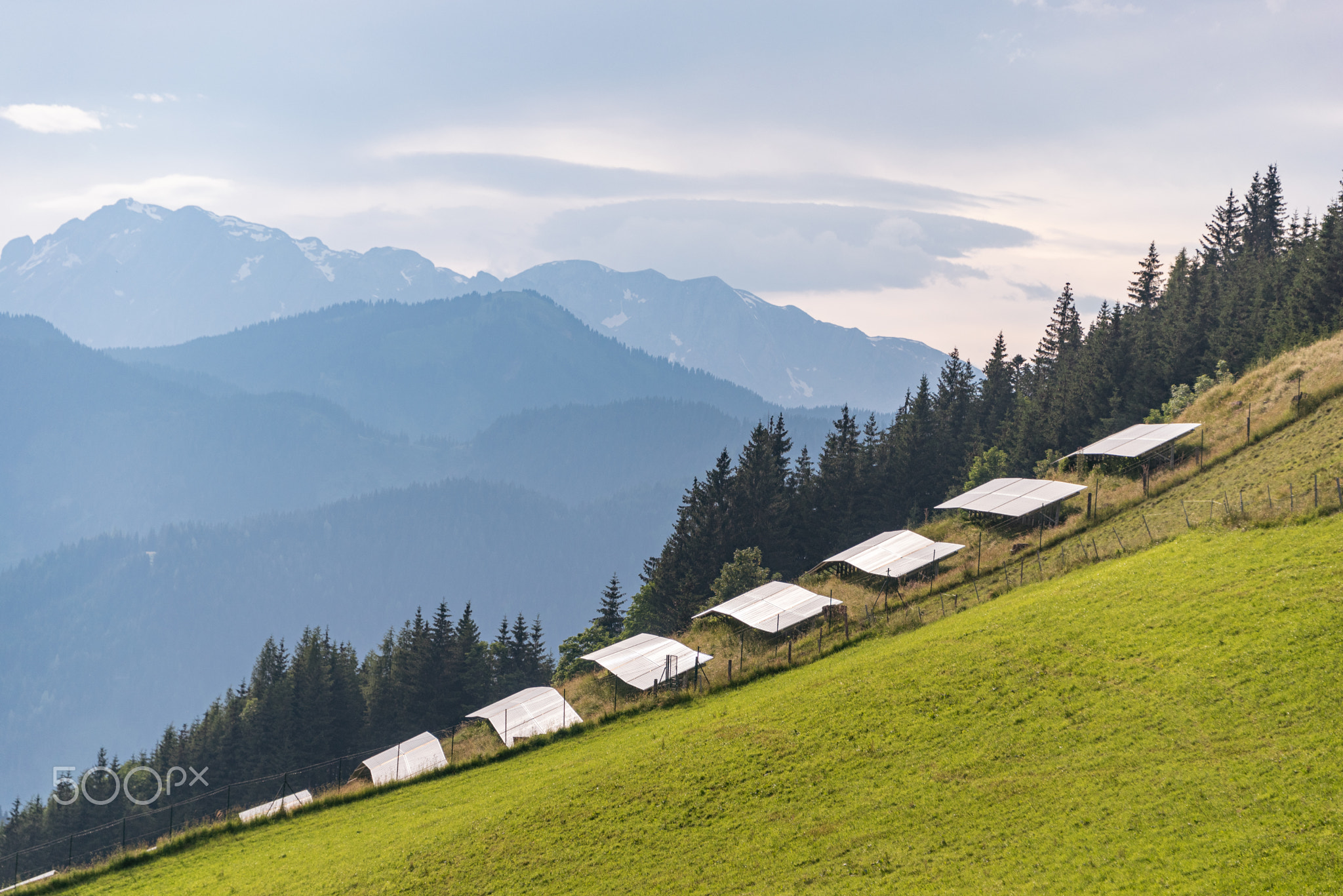 Photovoltaic, solar panels with alpine mountains