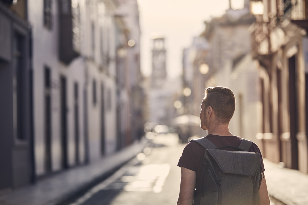 Traveler with backpack on street of old town by Jaromír Chalabala on 500px.com