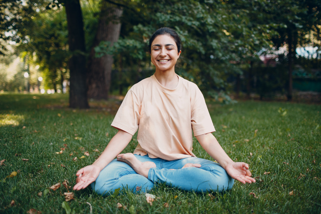 Indian woman doing yoga in outdoor summer park by Max Chernishev on 500px.com