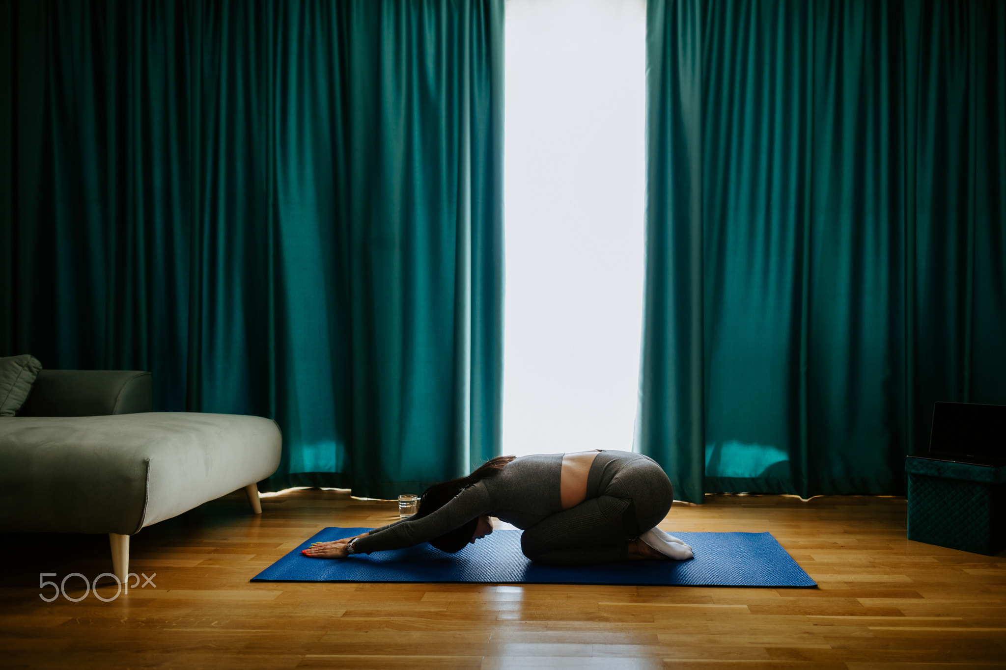 Young woman practicing yoga at home. Posture practicing