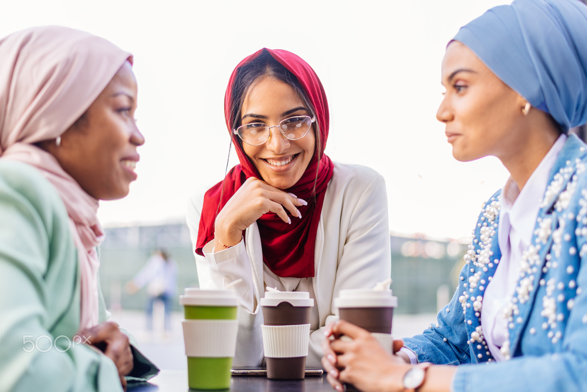 Beautiful muslim girl wearing hijab bonding outdoors