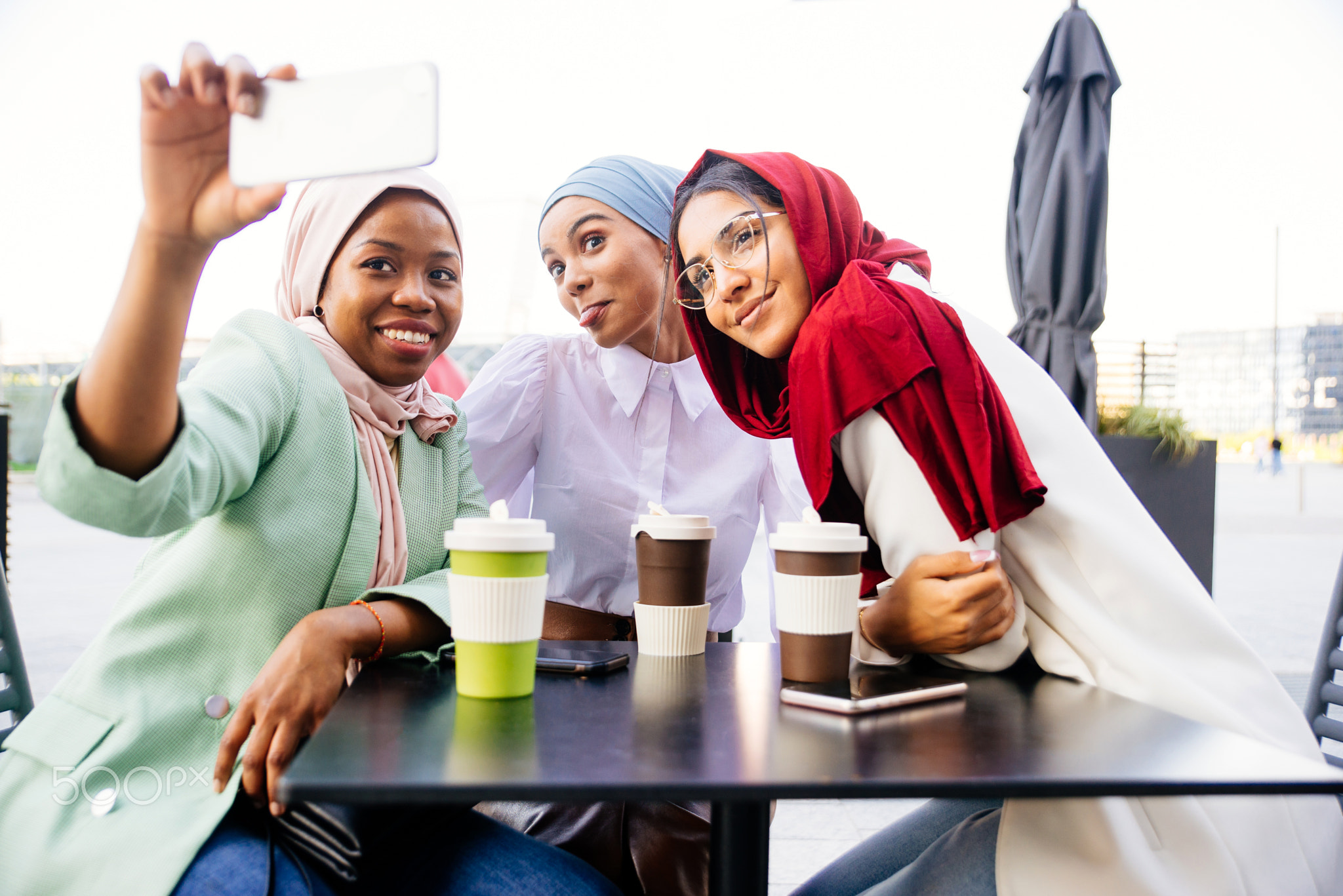 Beautiful muslim girl wearing hijab bonding outdoors