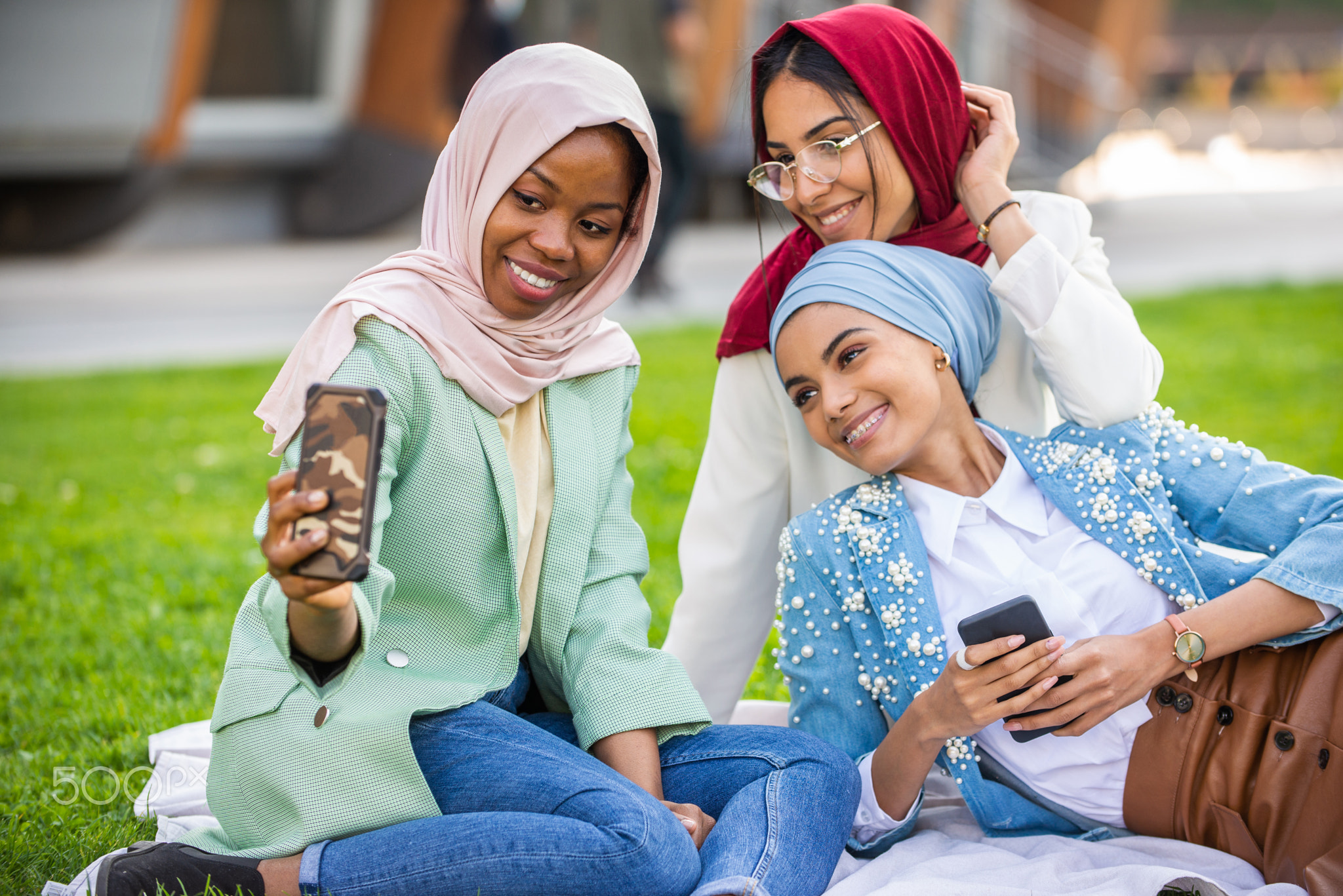 Beautiful muslim girl wearing hijab bonding outdoors