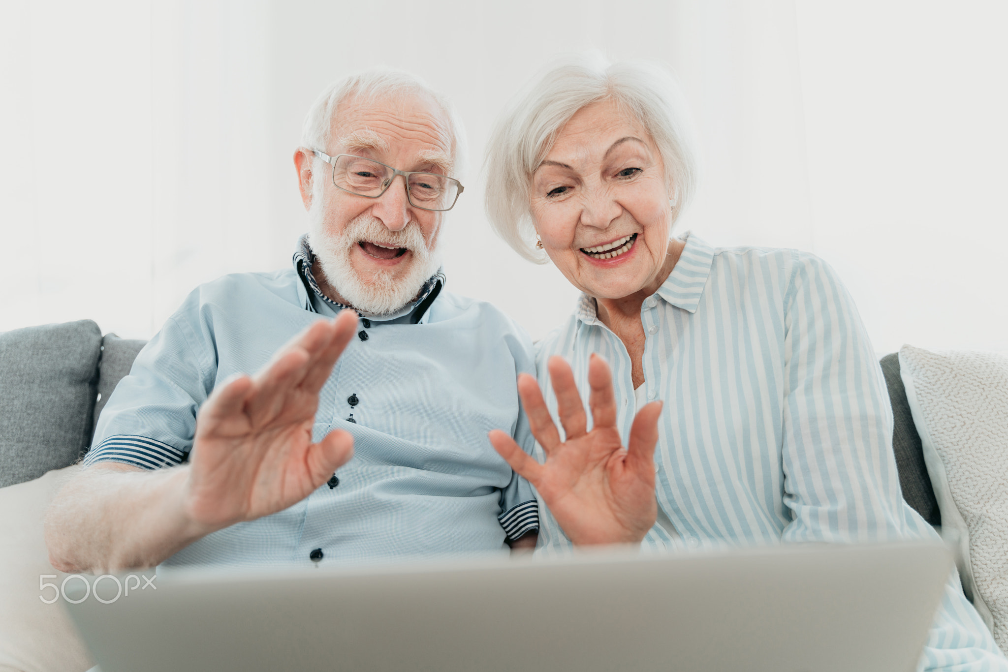 Elderly couple with computer laptop at home